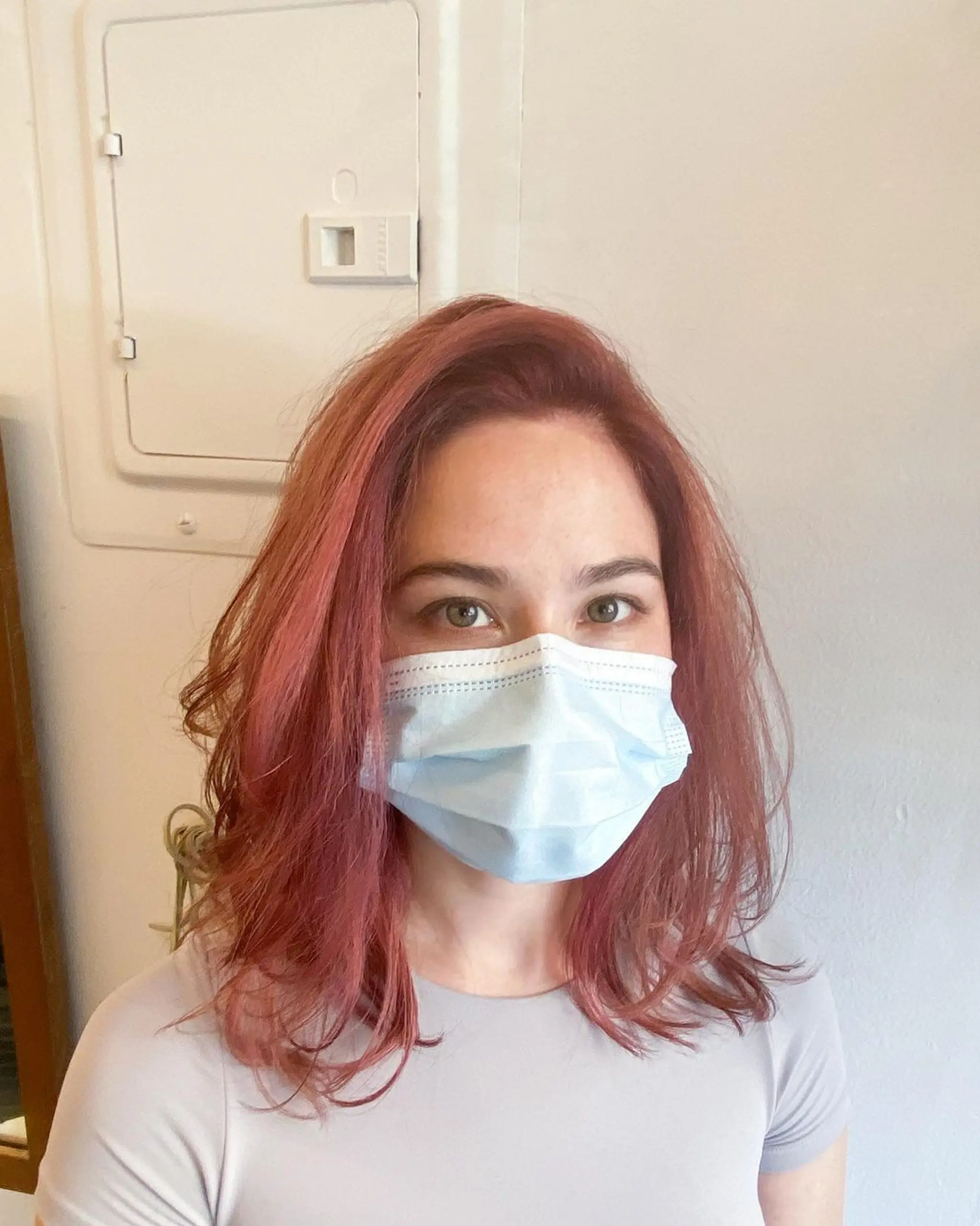 Medium-length straight hair with vibrant red, copper, and pink hues, blunt ends, and minimal layers for a sleek and natural look. 2
