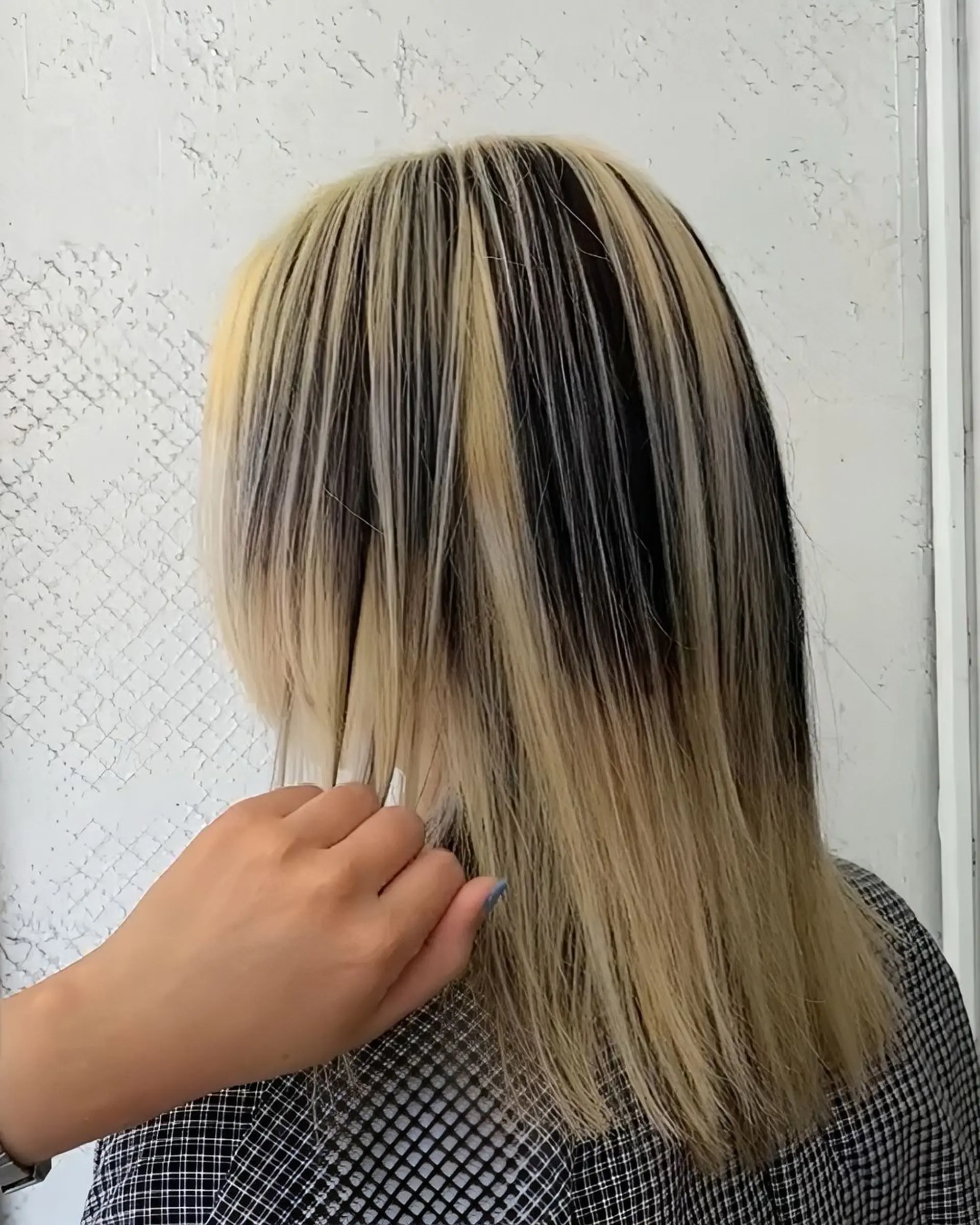 Striking two-tone style with sleek, straight layers in a bold contrast of blonde and black. 1