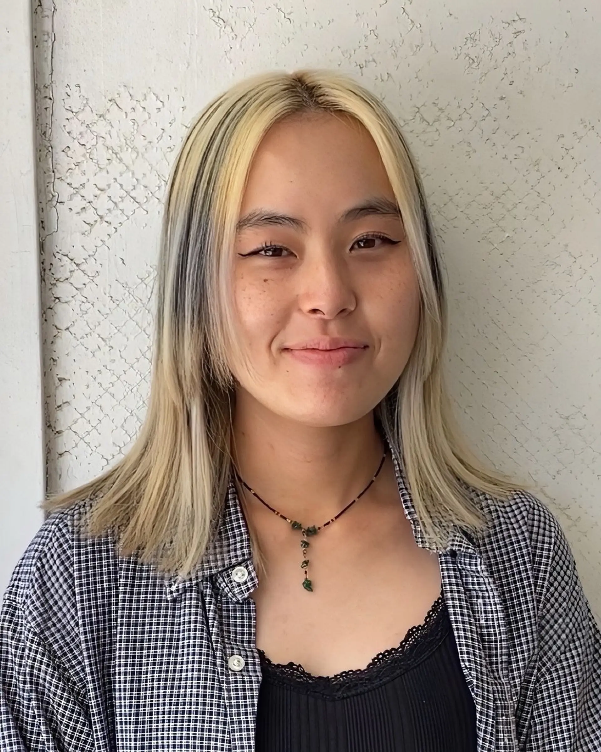 Striking two-tone style with sleek, straight layers in a bold contrast of blonde and black. 2