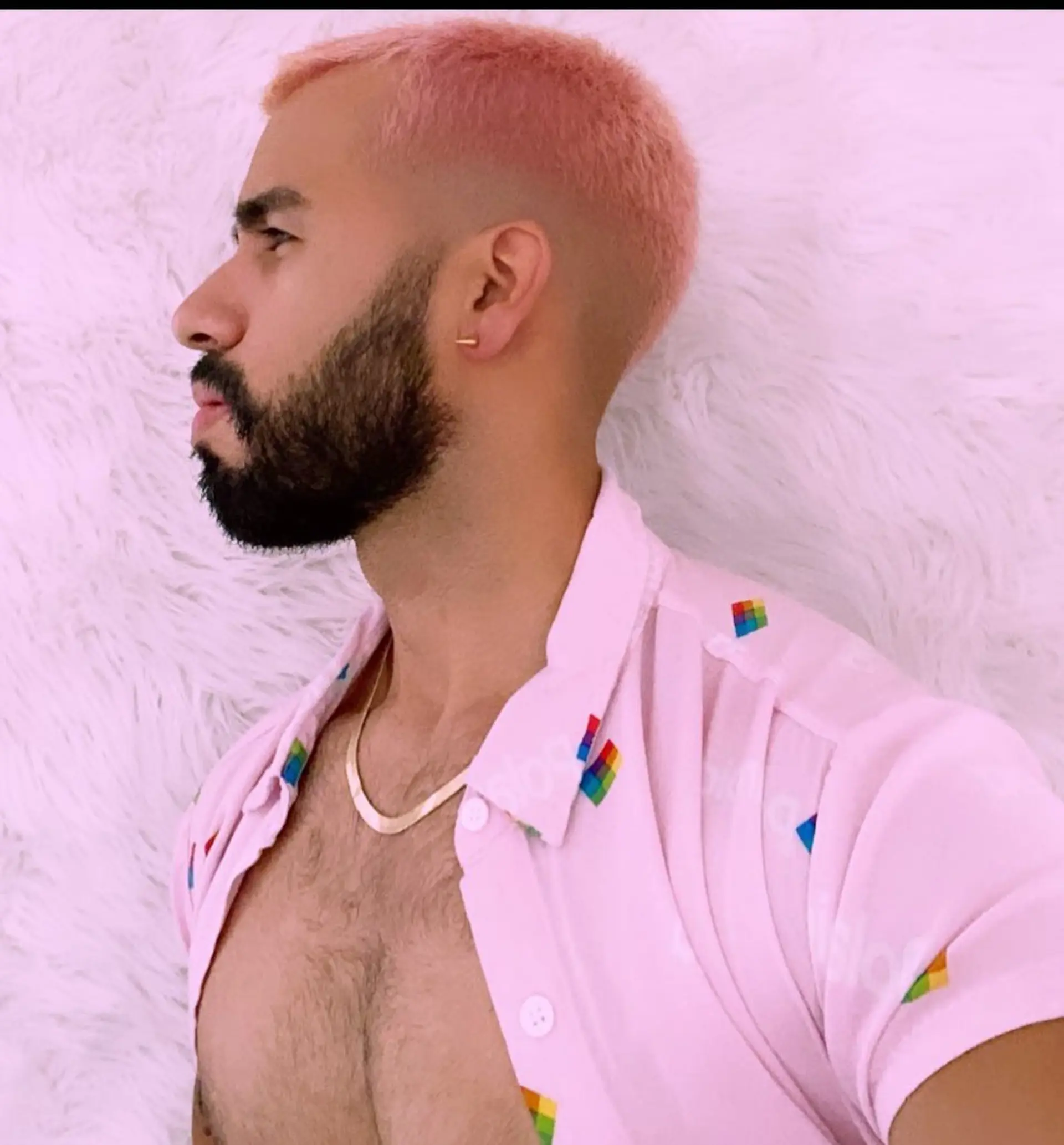 A textured buzz cut with a clean skin fade, dyed in a vibrant pastel peach-pink hue. 1