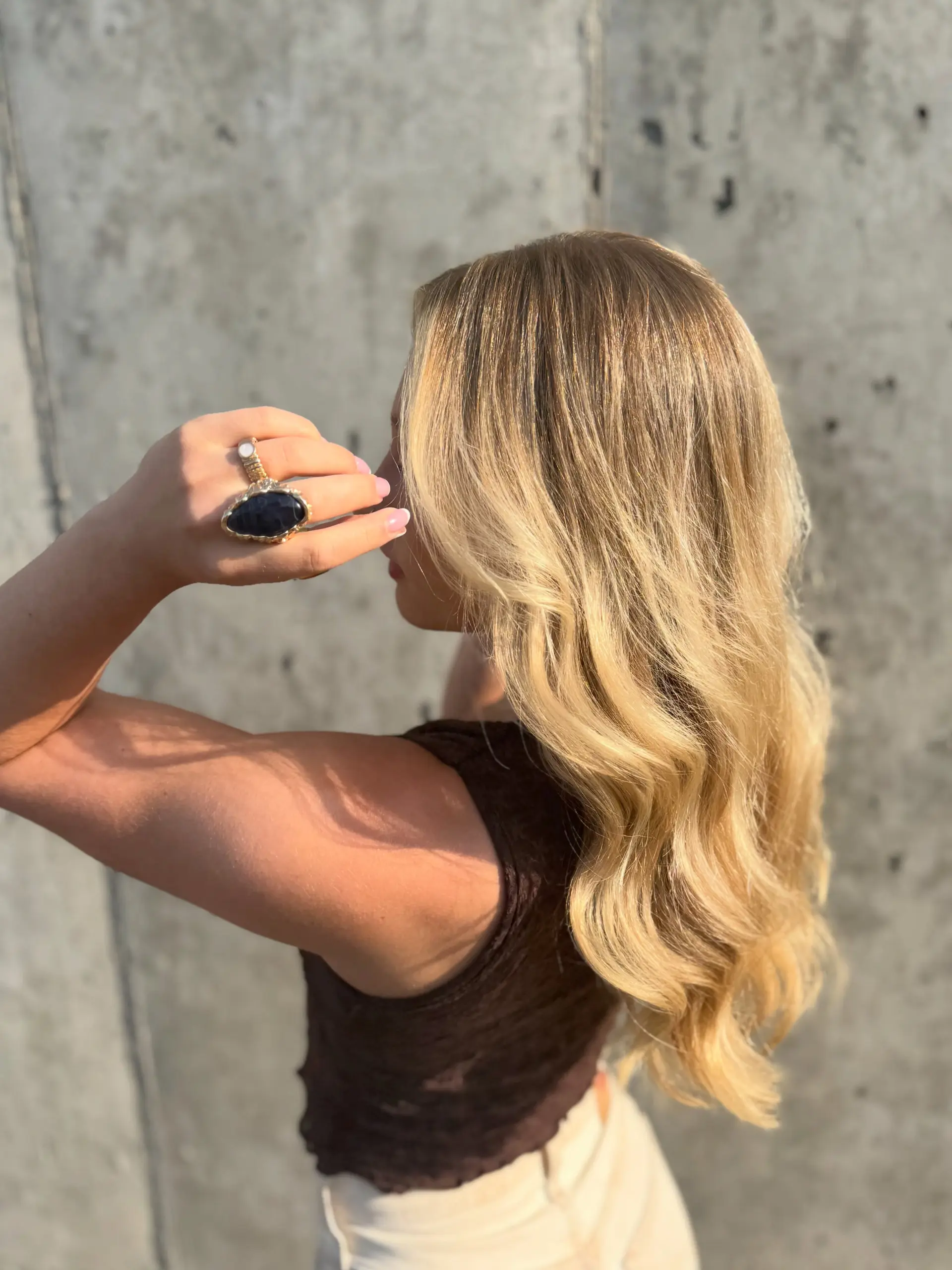 Long dimensional blonde hair styled in soft, polished waves cascading down the back. 1