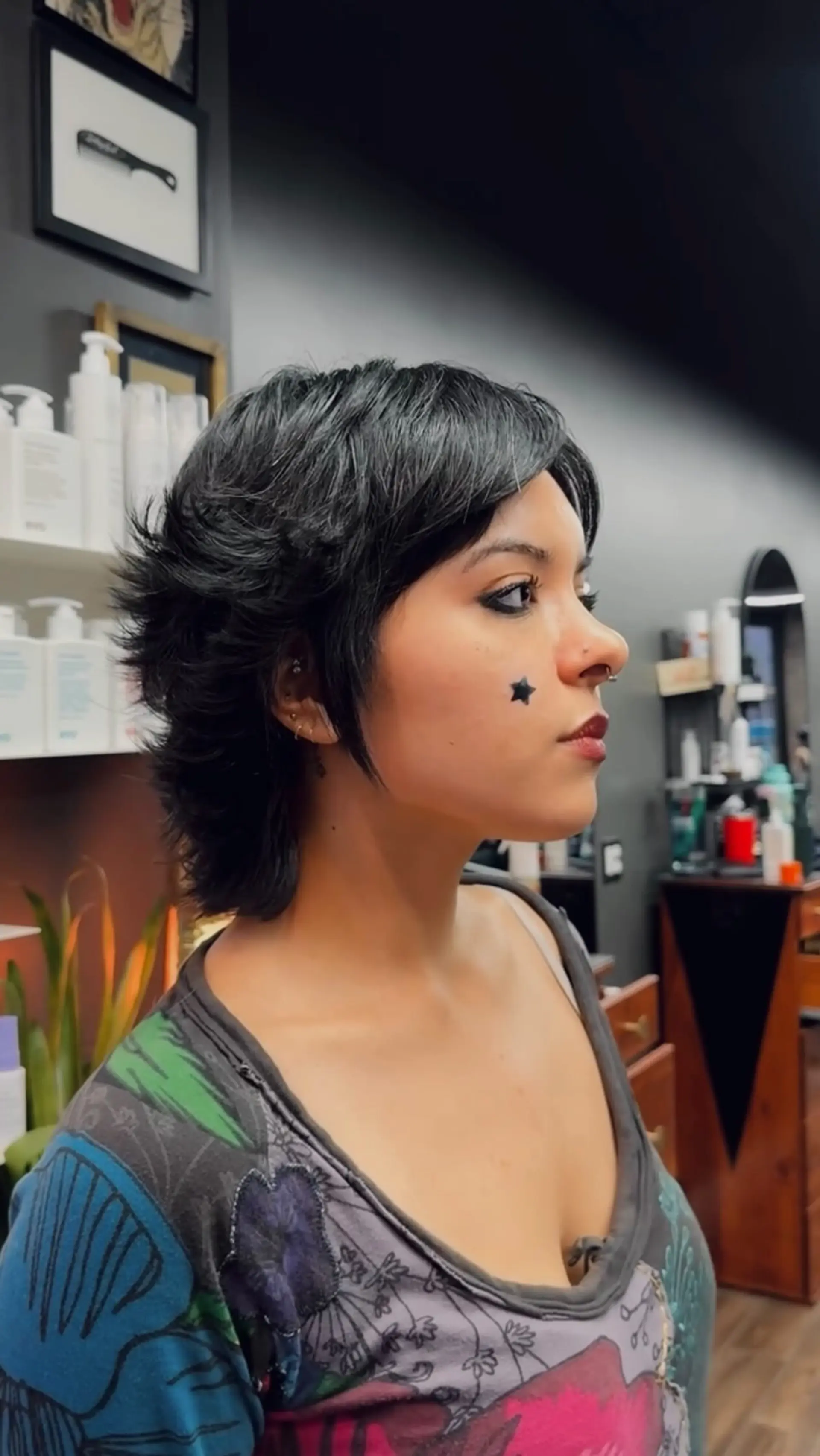 A textured short shaggy mullet haircut featuring piecey micro layers, face-framing sideburn strands, and a feathered nape. 1