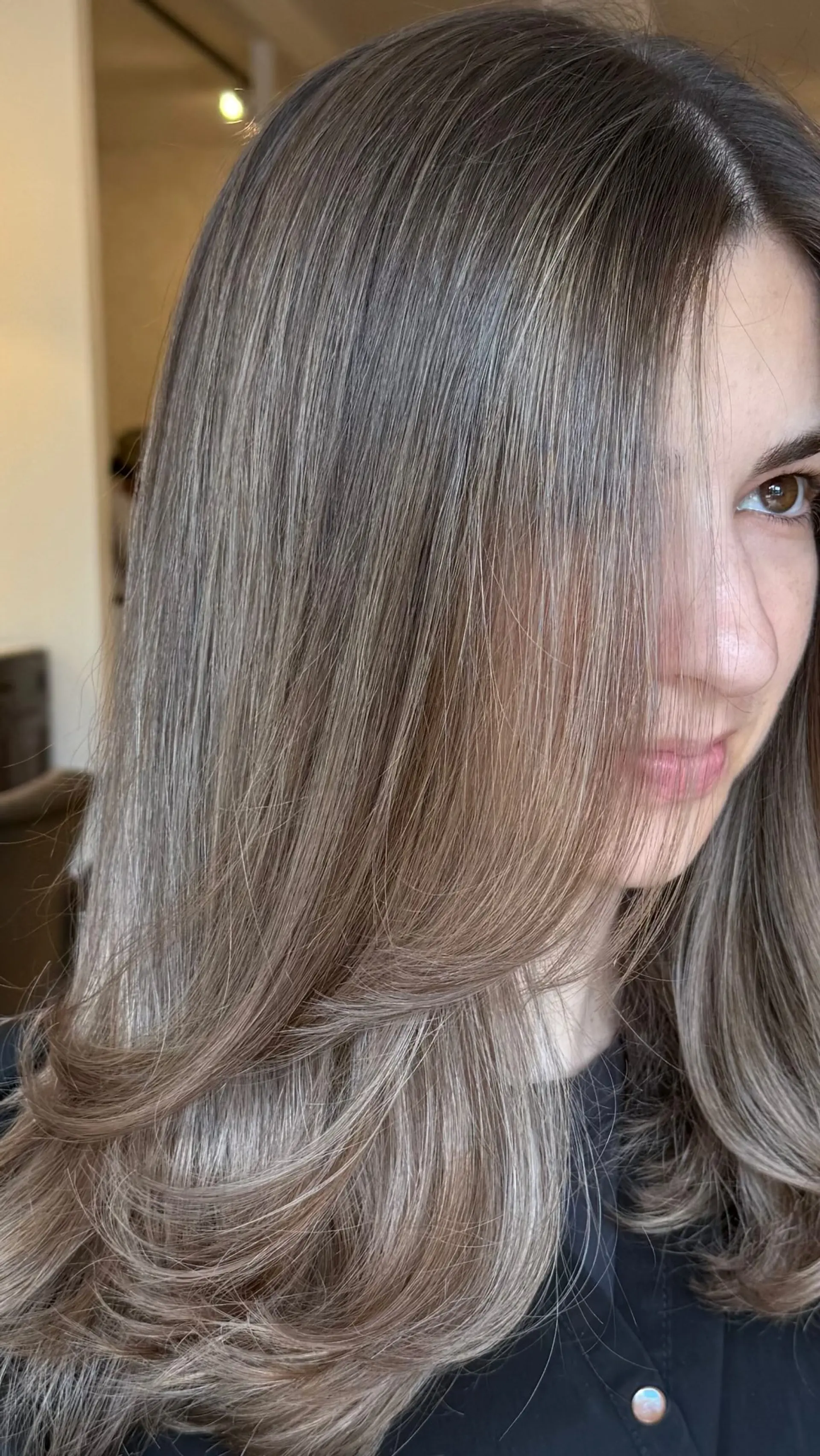 Silky, smooth ash brown hair with seamless dimensional highlights and soft face-framing layers styled in a voluminous blowout with flipped ends. 1