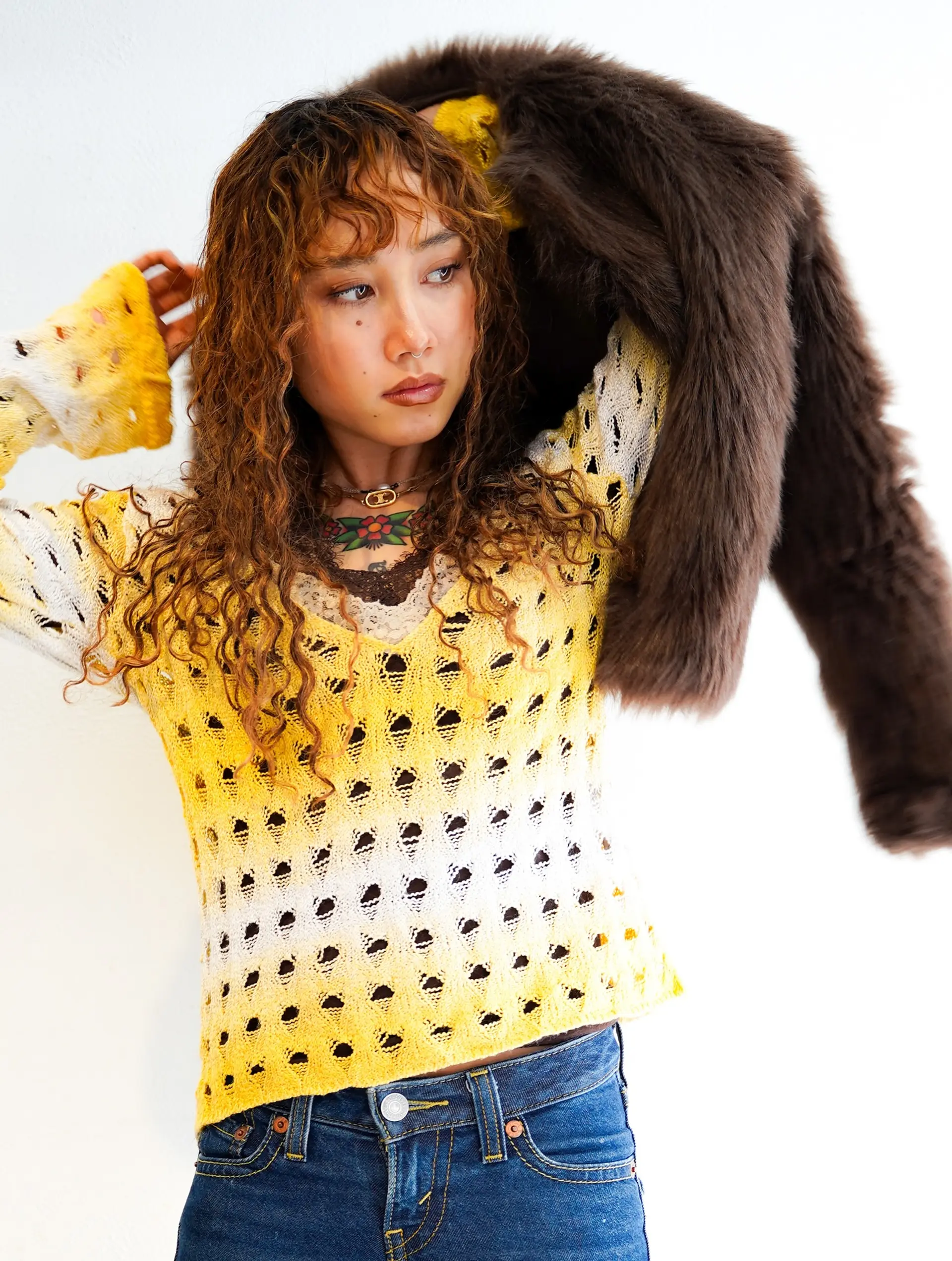 Medium-length curly layered shag with soft ringlets and textured curly bangs in a warm caramel-brown shade. 1