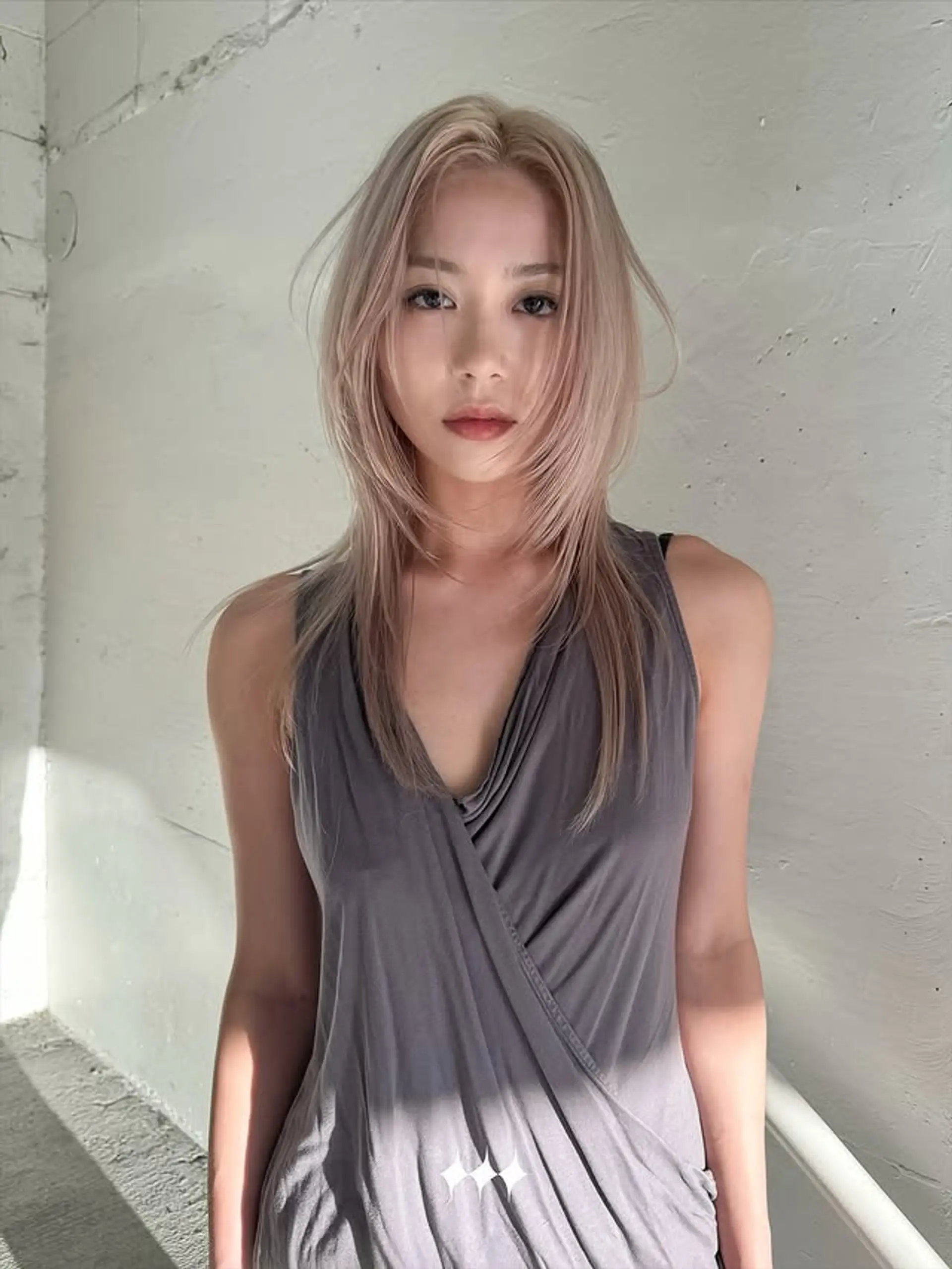 A medium-length shaggy hairstyle with face-framing layers and textured ends. 1