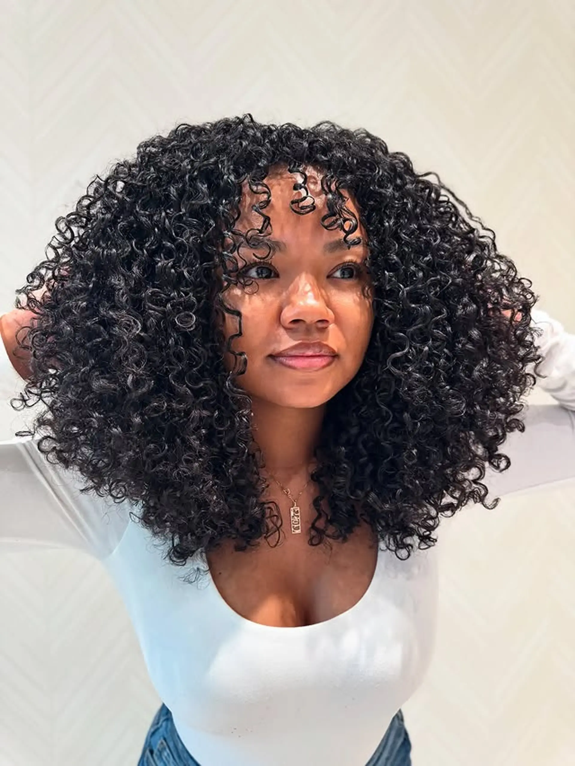 A medium-length curly bob with curly bangs. 1