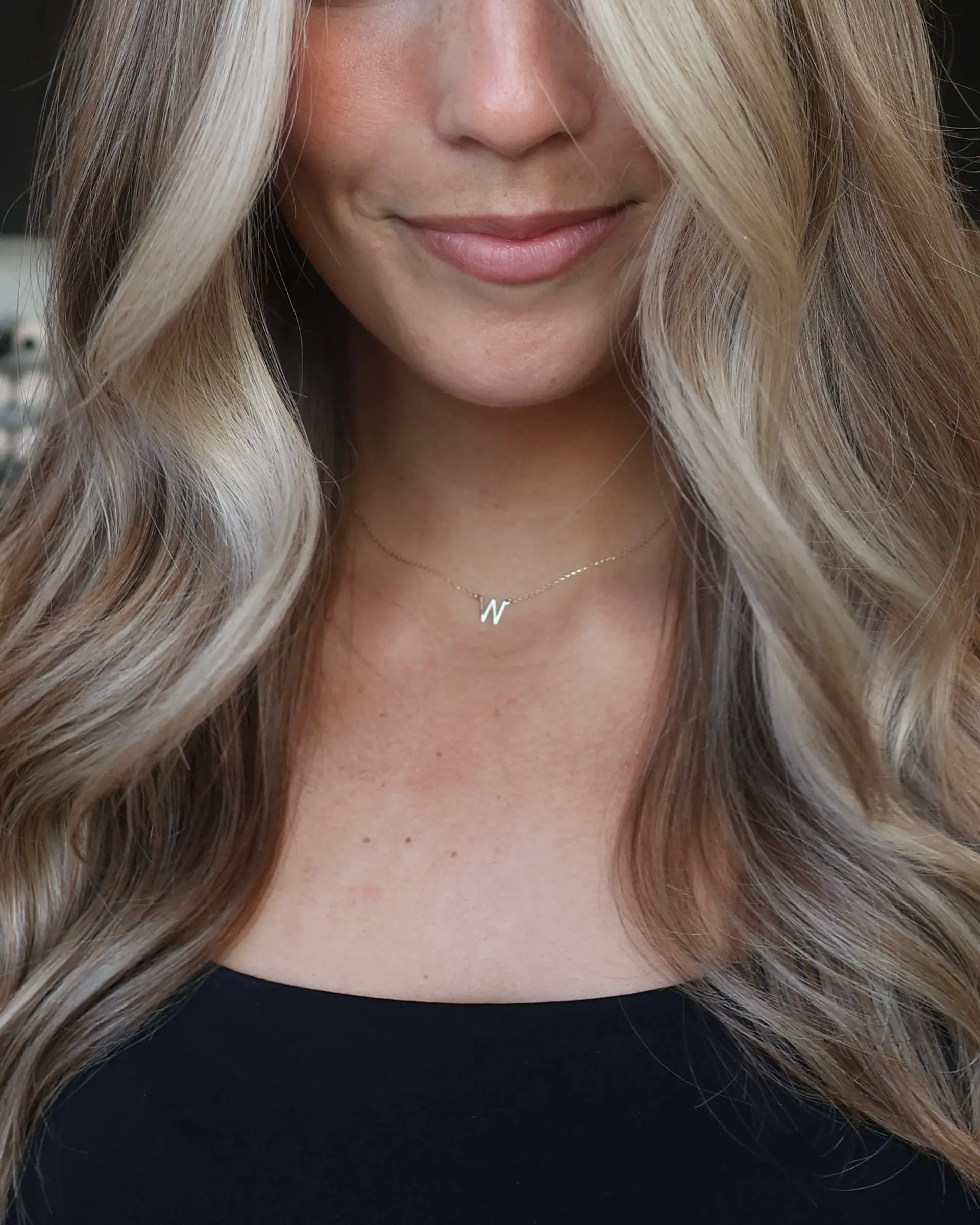 A wavy medium-length style with money piece highlights framing the face. 3