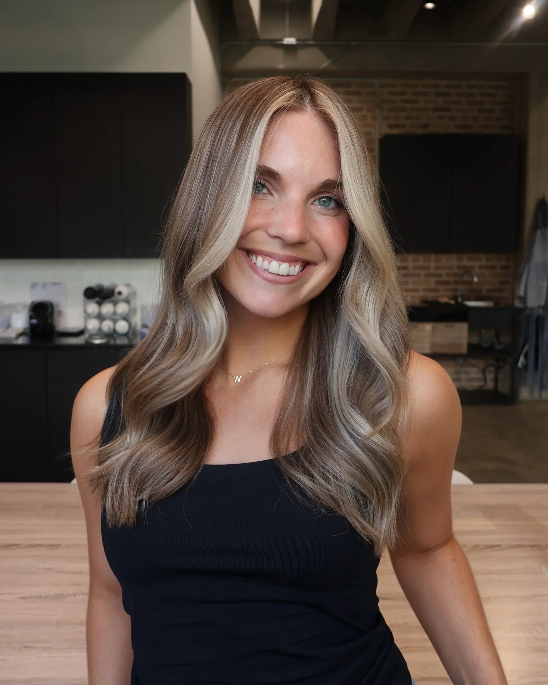 A wavy medium-length style with money piece highlights framing the face. 4