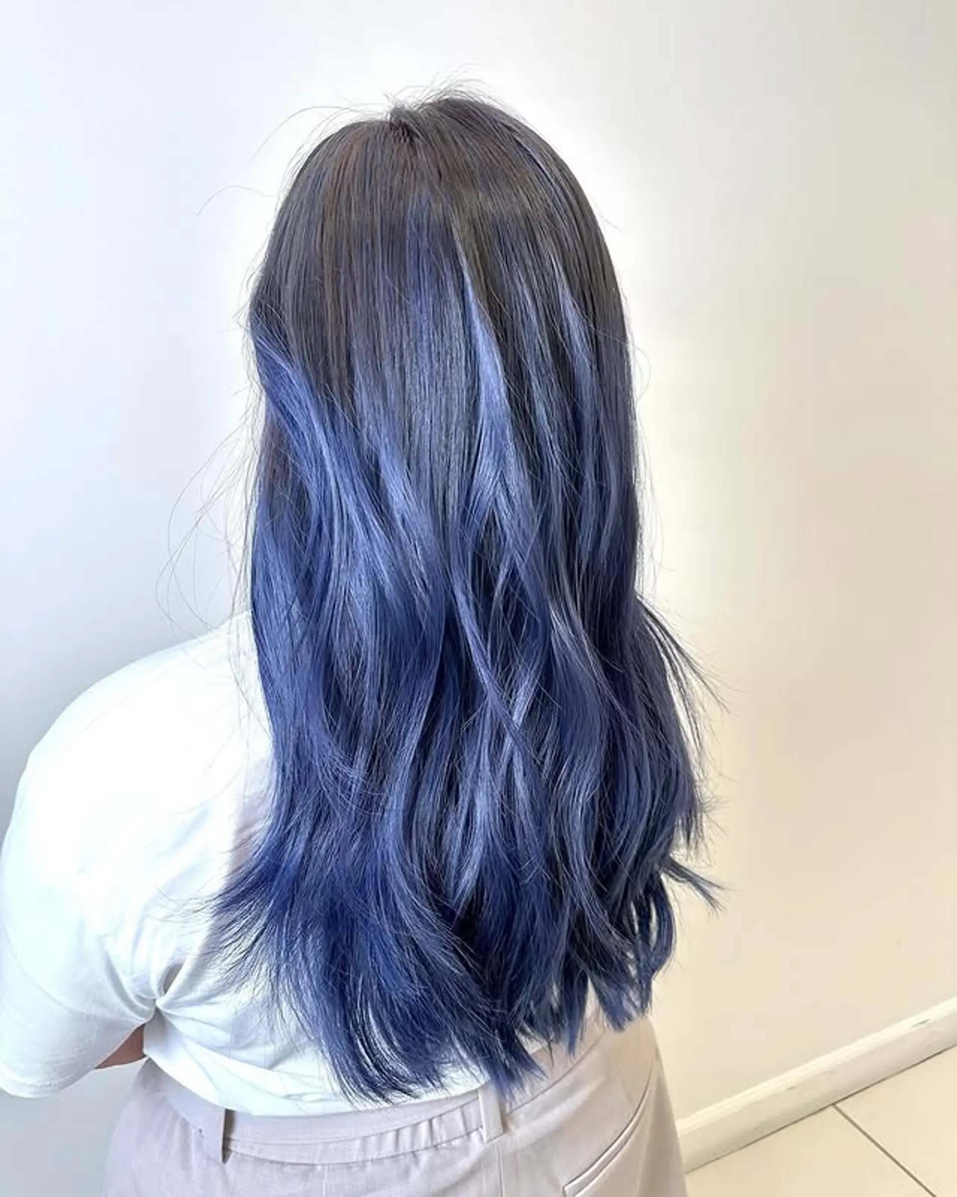 Long wavy hair with a dark brown to blue ombre and layered haircut. 1