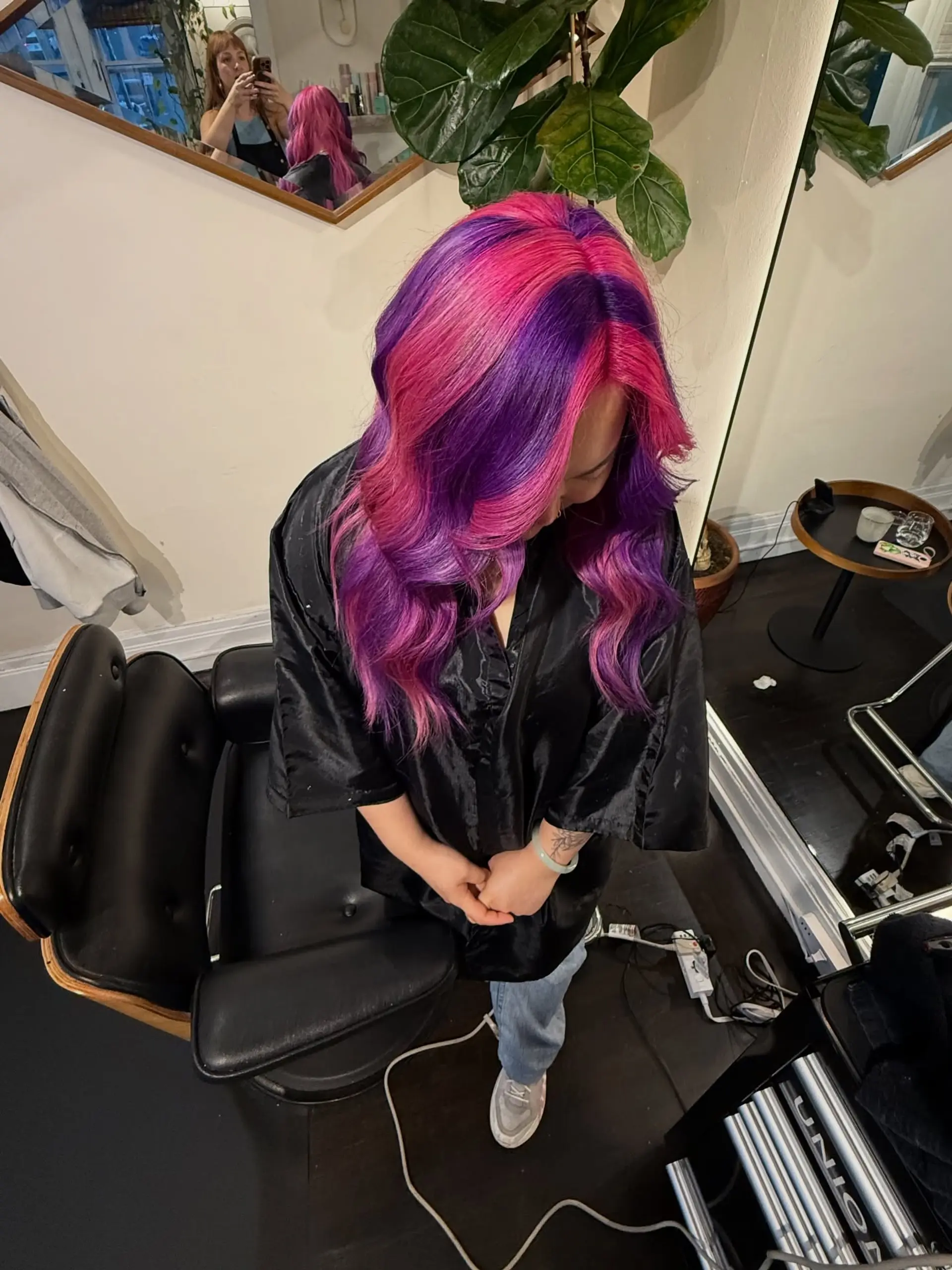 Vibrant color-blocked hair featuring alternating sections of electric purple and bright magenta pink, styled into soft waves. 1