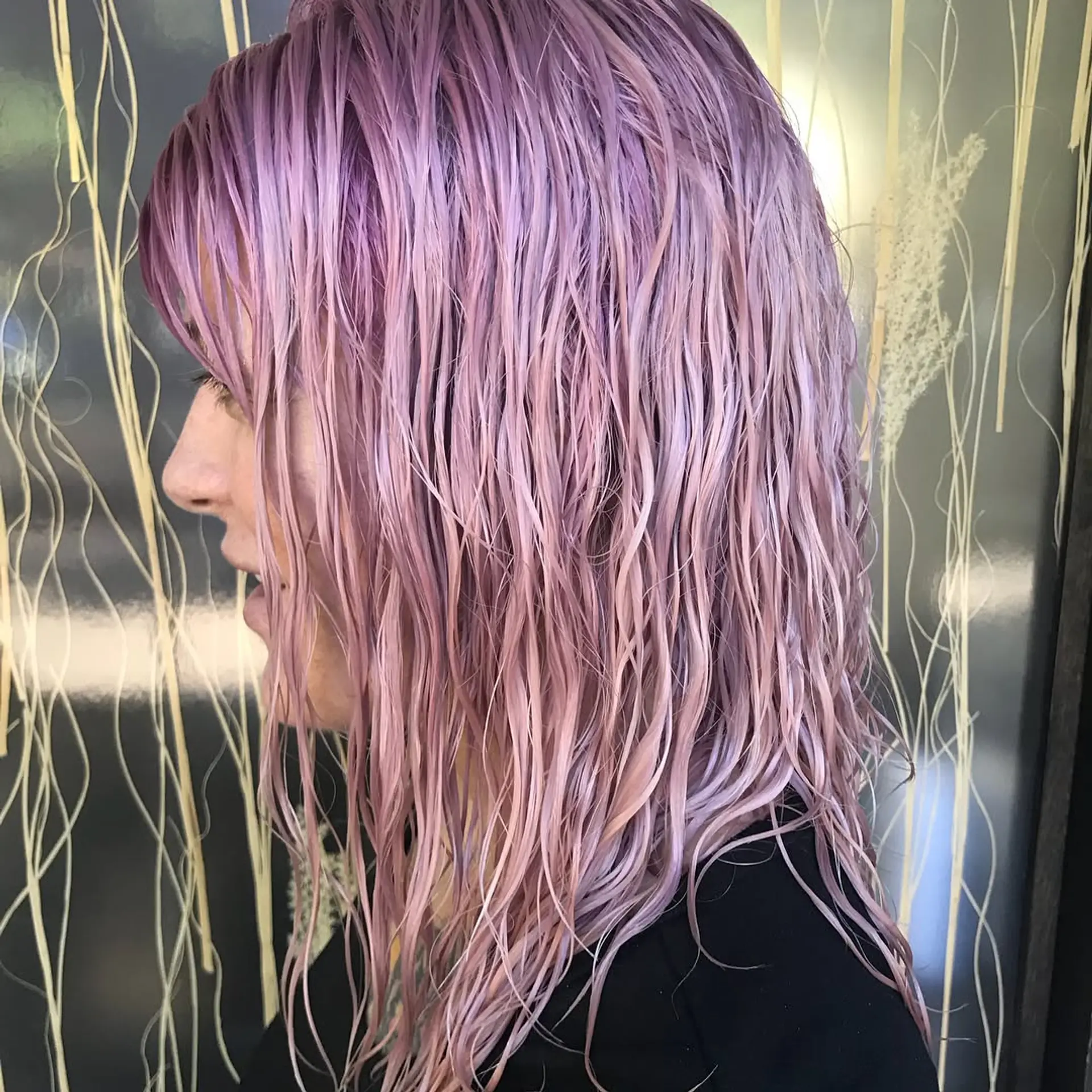 Wet-styled medium-length hair with textured fringe colored in a vibrant pastel bubblegum and mauve pink shade. 1