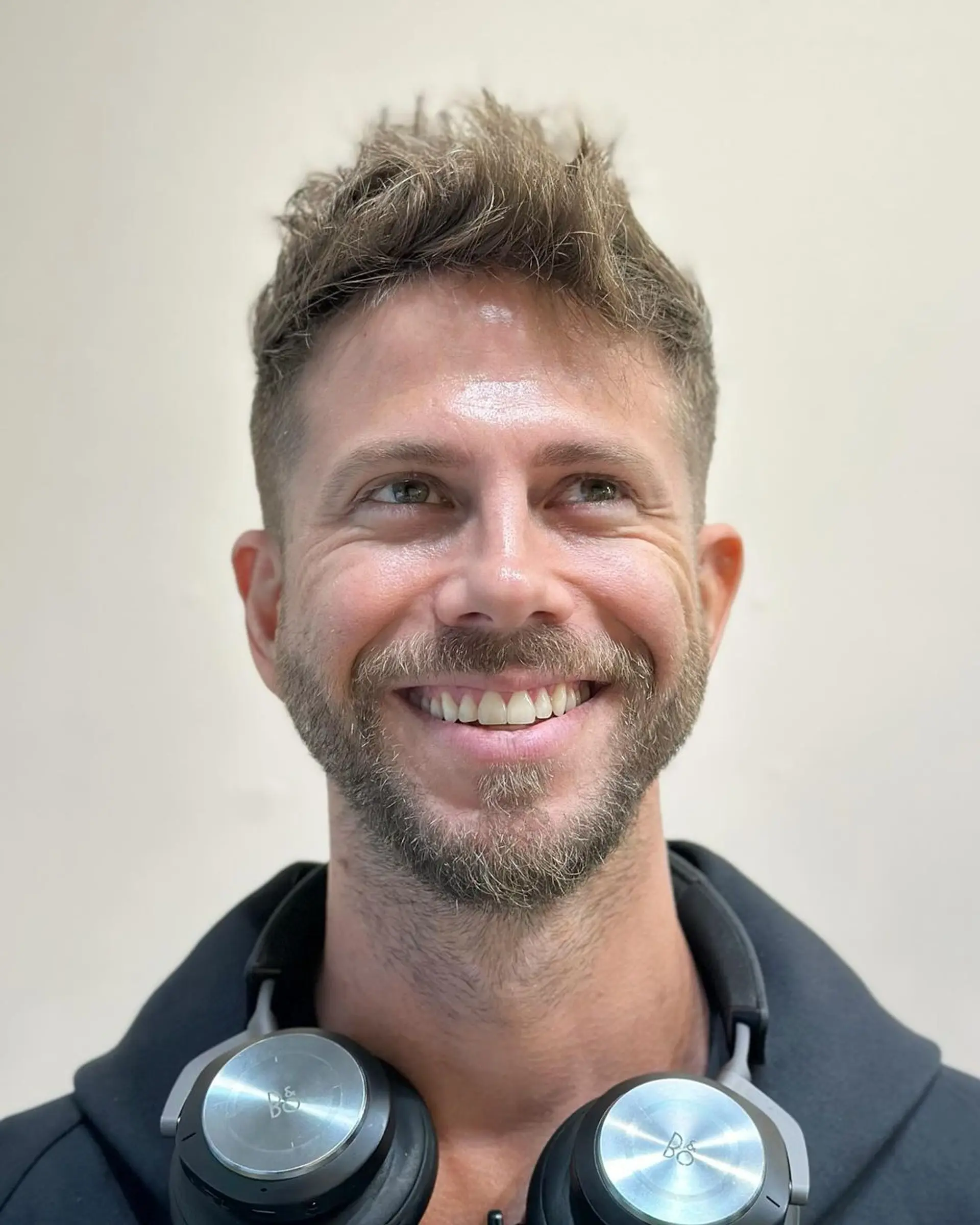 An edgy, textured mohawk with a high fade, featuring dark brown, wavy hair with significant volume on top and subtle tapering at the back. 3