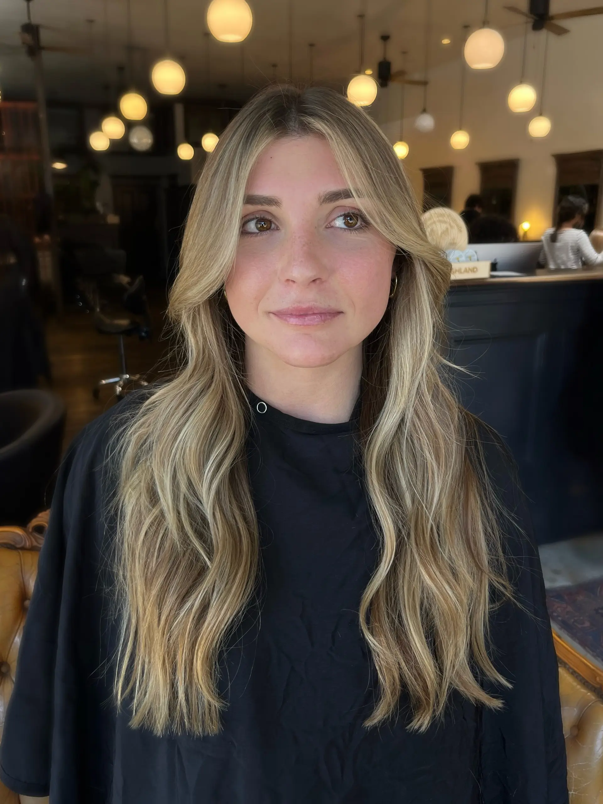 Long lived-in golden blonde hair with soft, loose waves and face-framing curtain layers. 1