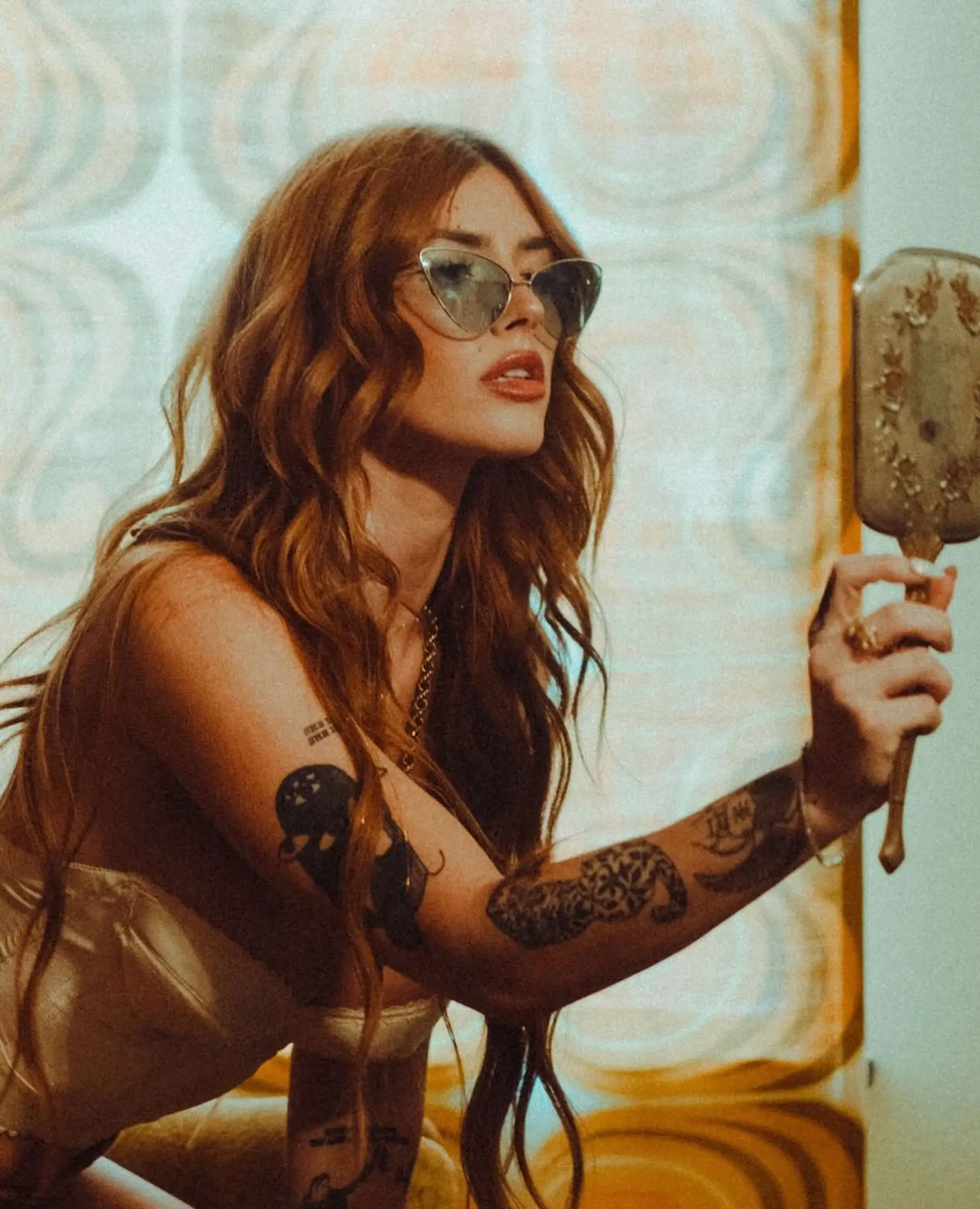 Long, warm copper hair styled into soft, brushed-out glam waves with radiant shine and effortless texture. 1