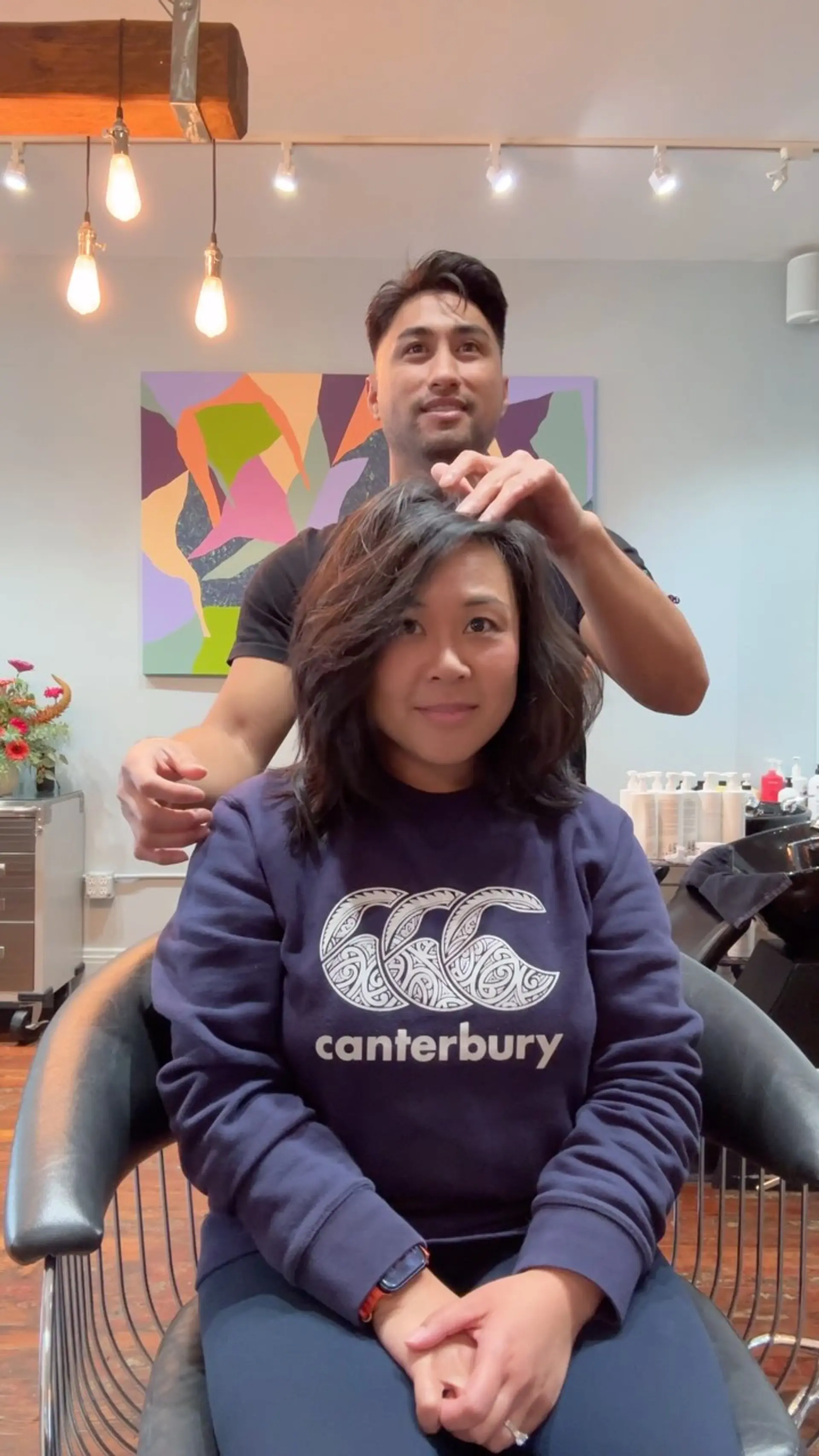 A shoulder-length textured lob featuring face-framing layers and a deep side part with natural volume. 1