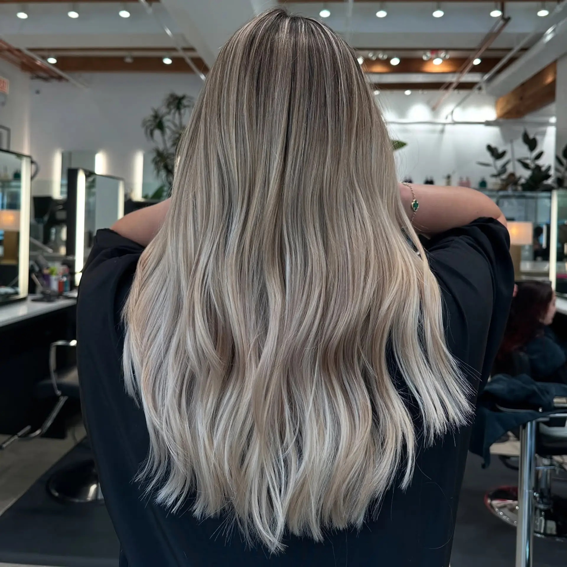 Long, wavy hair with an icy blonde balayage. 2