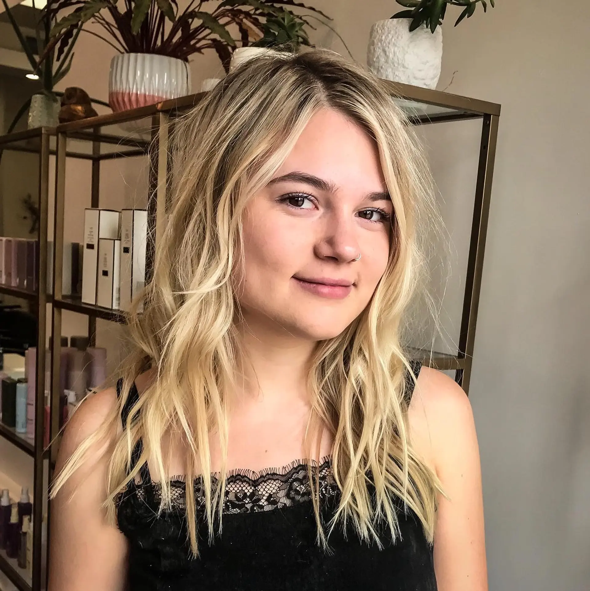 Shoulder-length bright blonde hair styled with textured, undone waves and a soft root smudge. 1