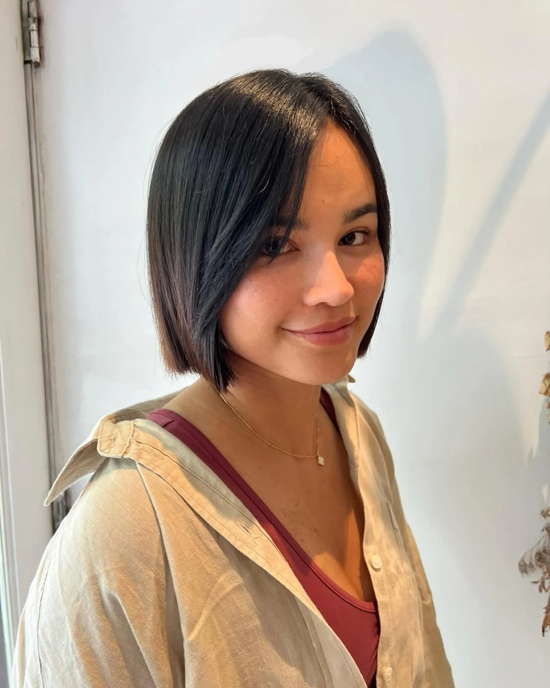 Sleek, chin-length blunt bob with minimal layering - Preview 1