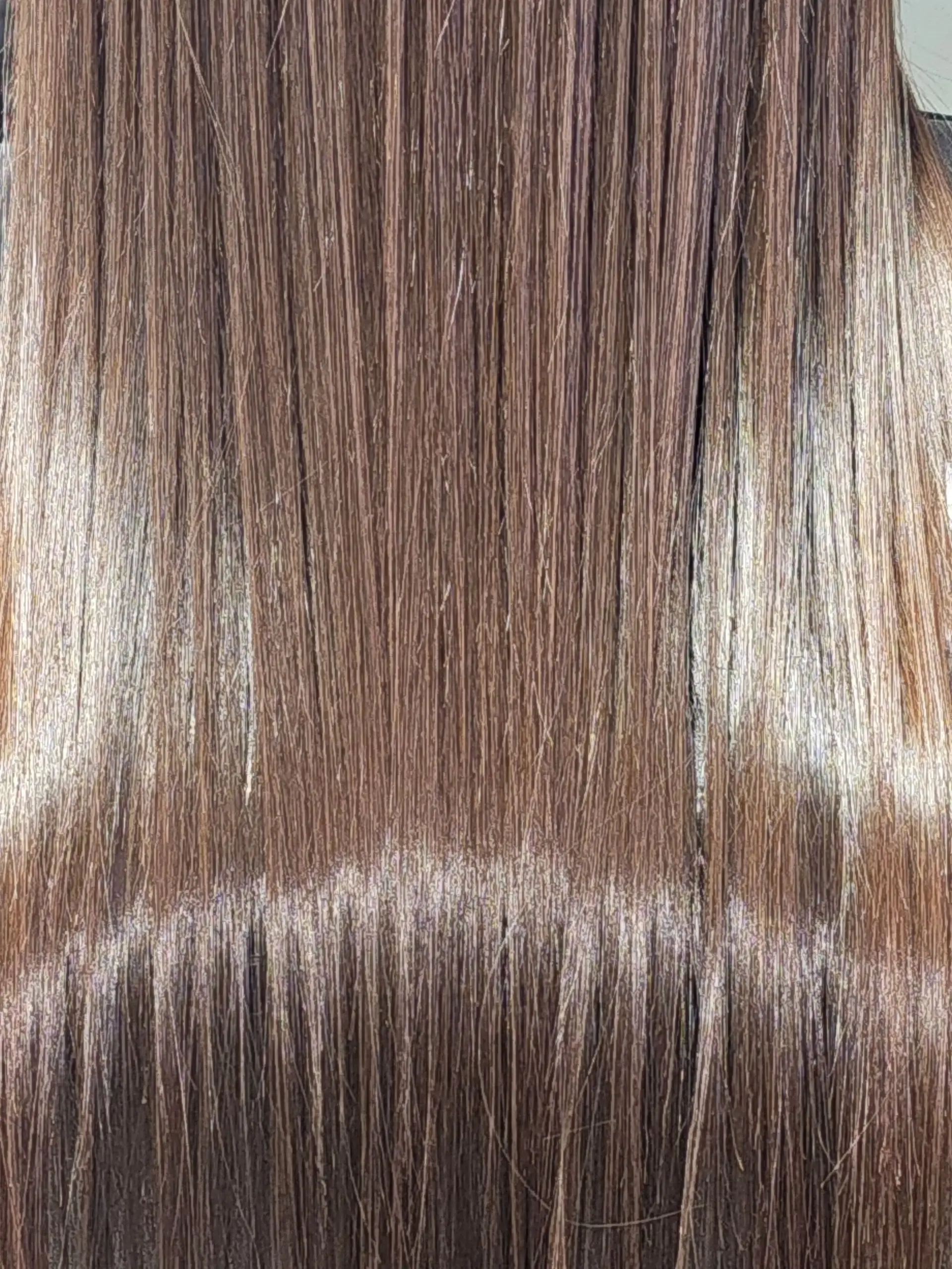 Ultra-sleek, pin-straight brown hair with high shine and a smooth finish. 1