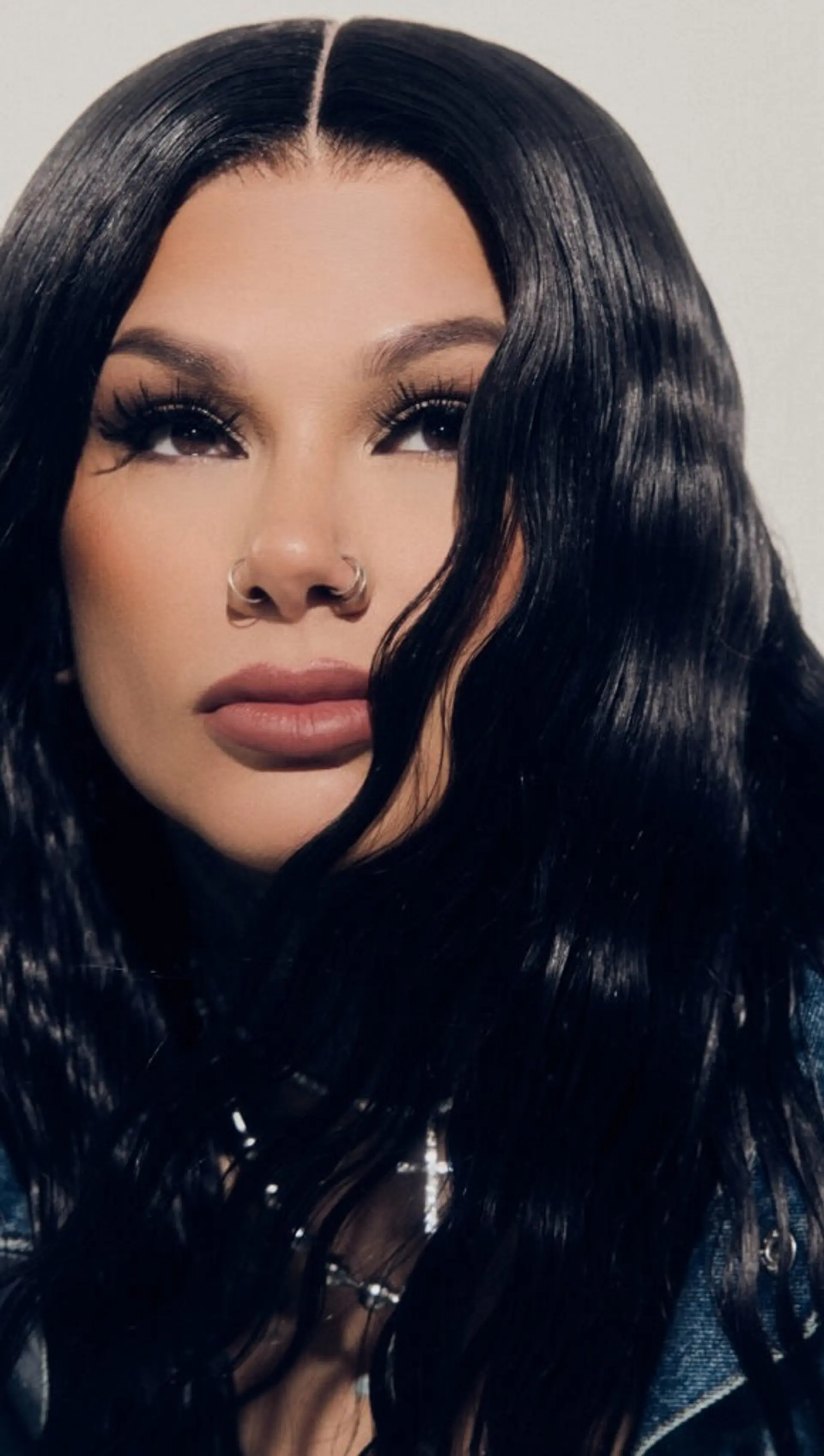 Long jet black hair styled into defined, glossy mermaid waves with a precise center part. 1