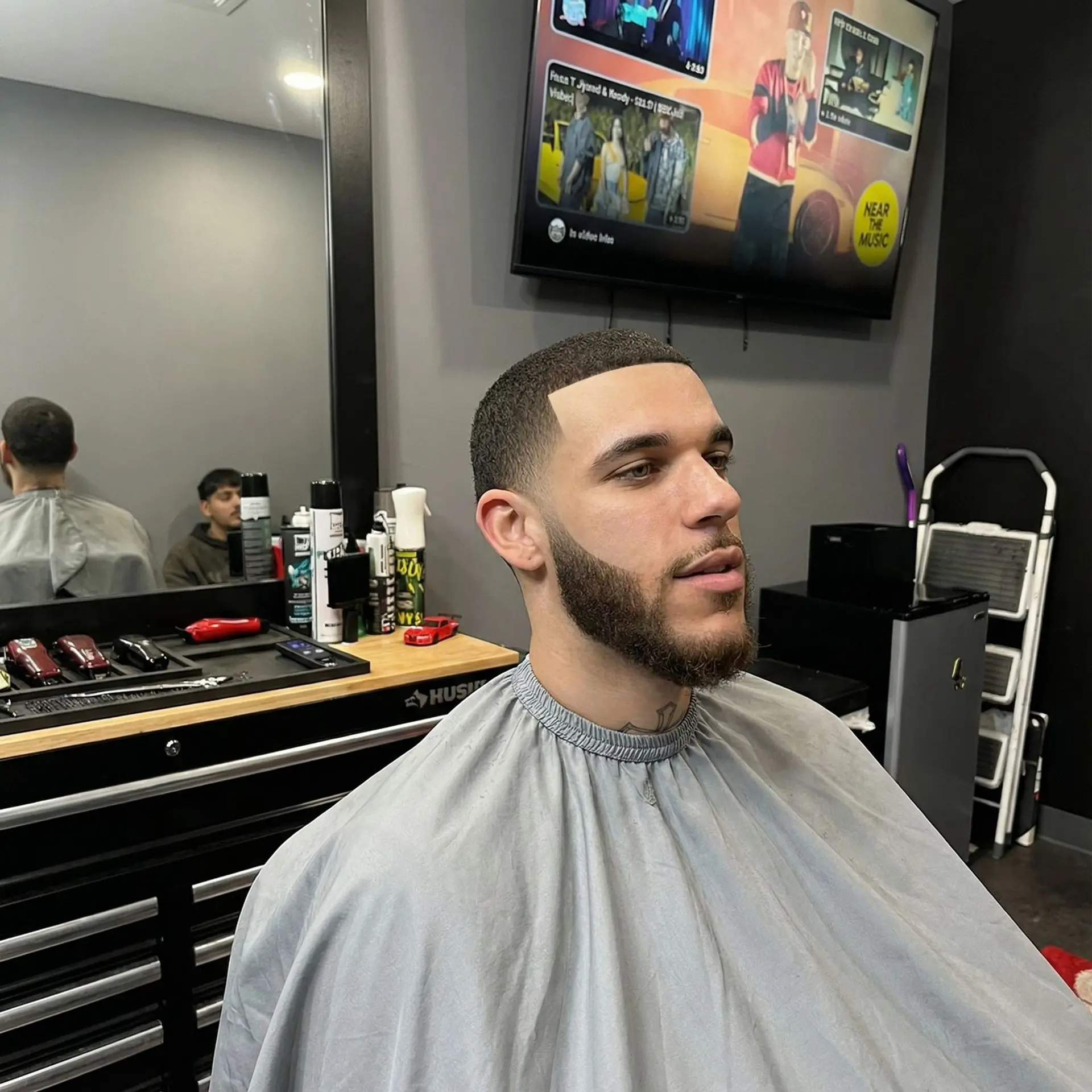 A clean, uniform buzz cut complemented by a sharp front line-up and a precisely groomed beard. 1