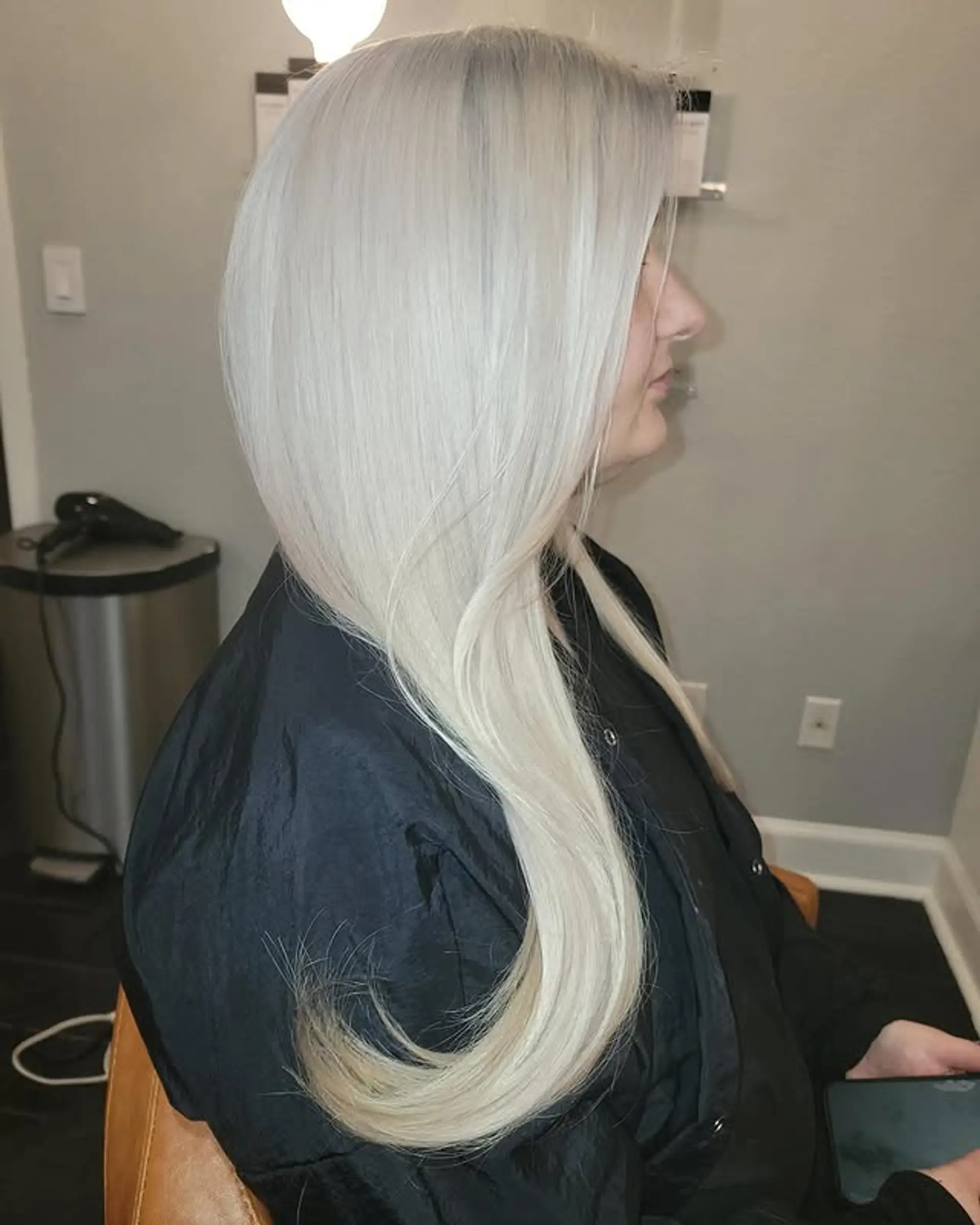A striking, full-head icy platinum blonde color applied to long, sleek, straight hair, creating a modern and vibrant aesthetic. 1