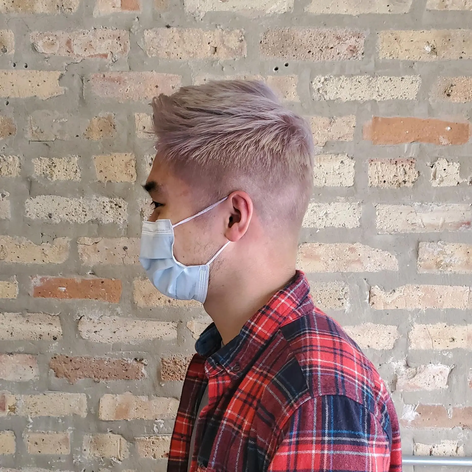 A textured short haircut with a subtle fade on the sides and back, colored in a soft pastel lavender shade. 1