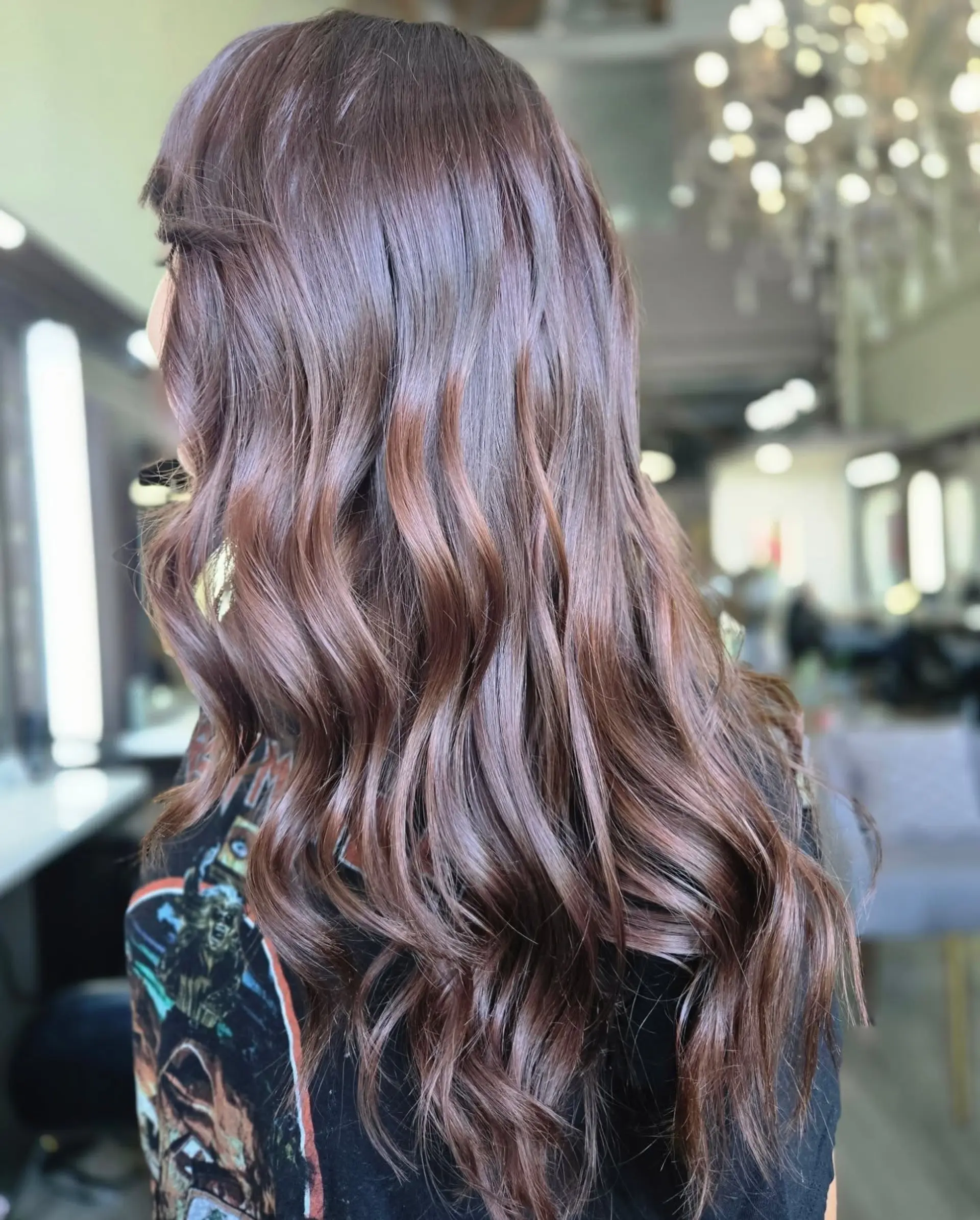 Long chocolate brown hair styled with soft, lustrous waves. 1