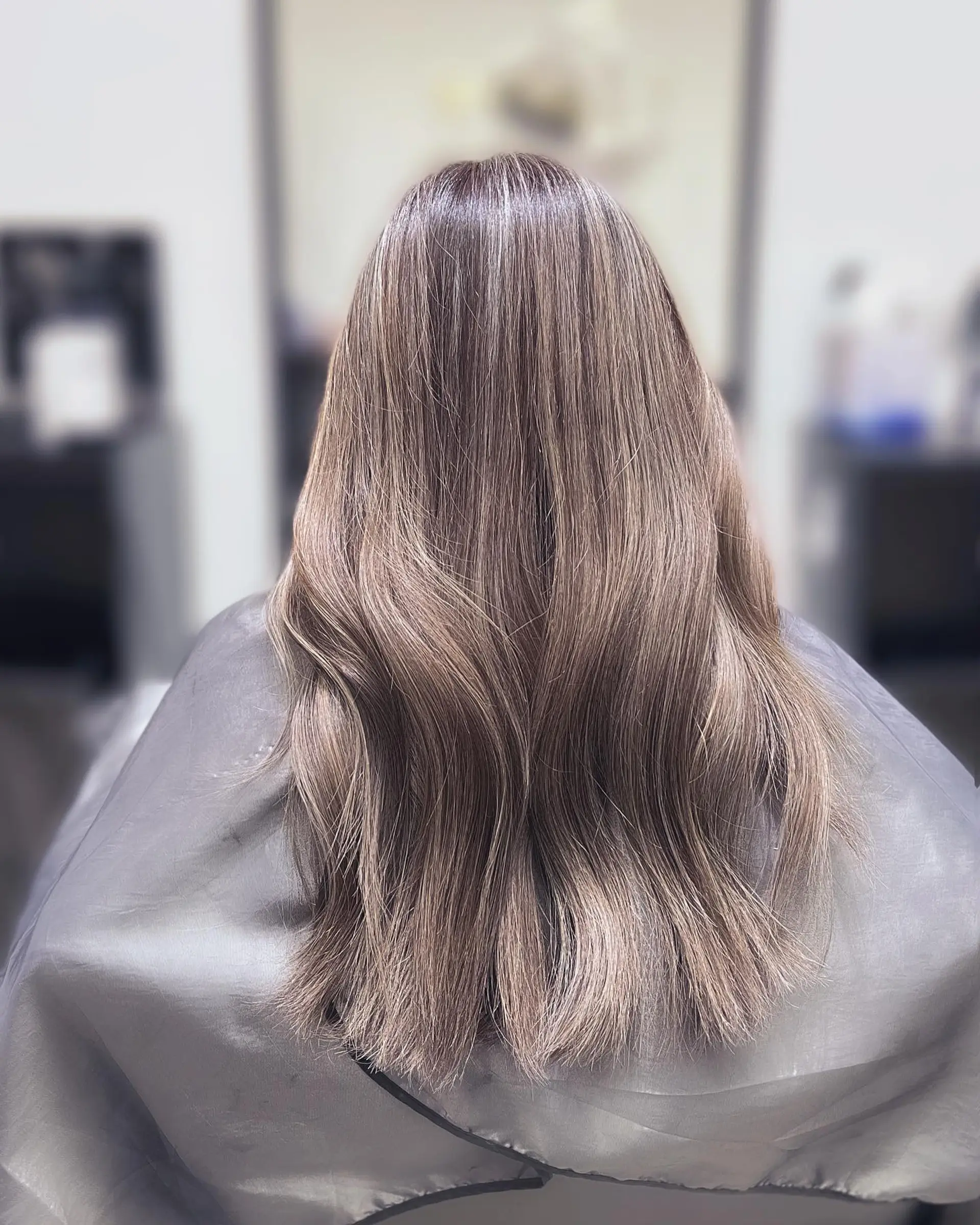 Long wavy hair with a subtle ash brown balayage. 1