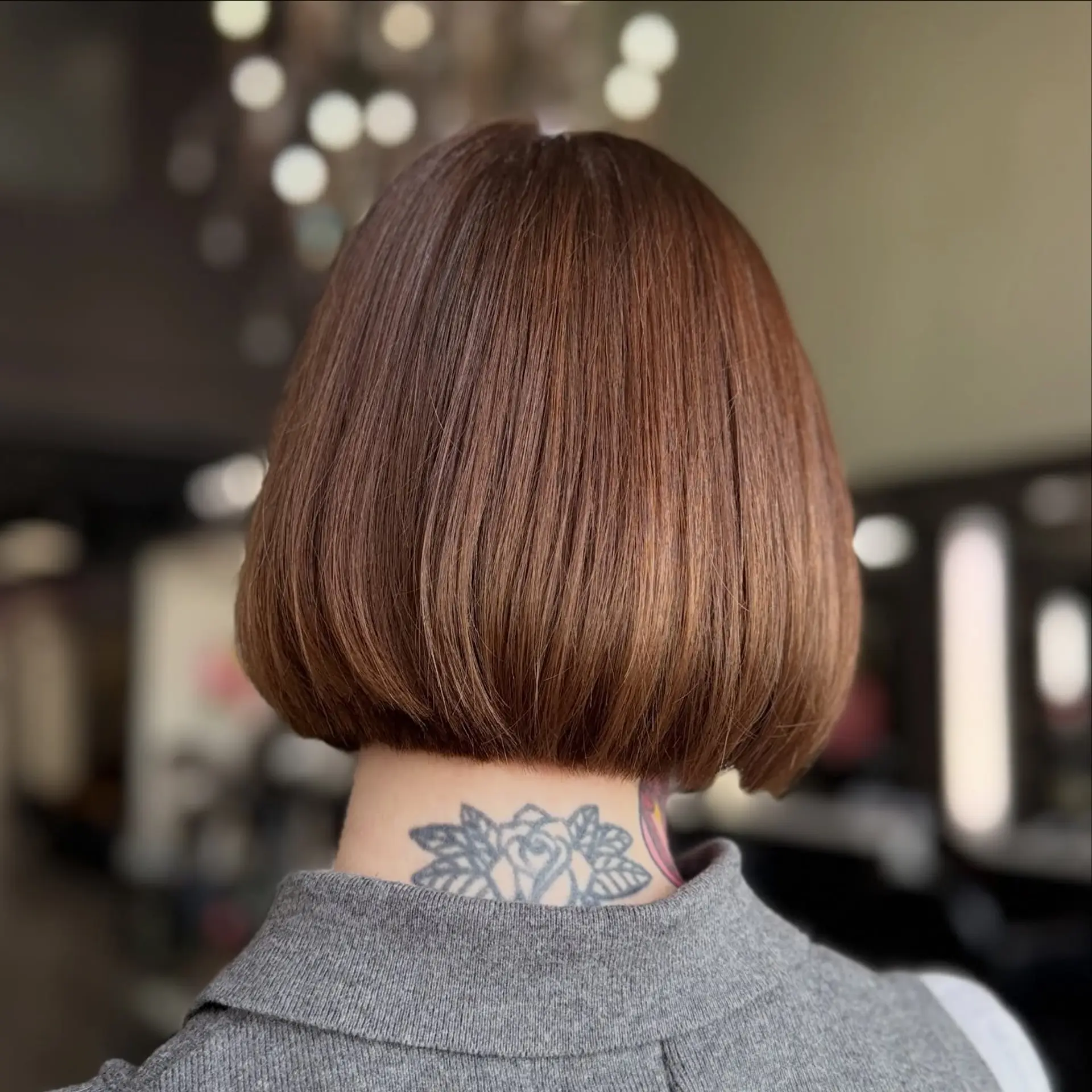 A sleek, chin-length blunt bob with gently beveled ends and a glossy, uniform warm brown tone. 1