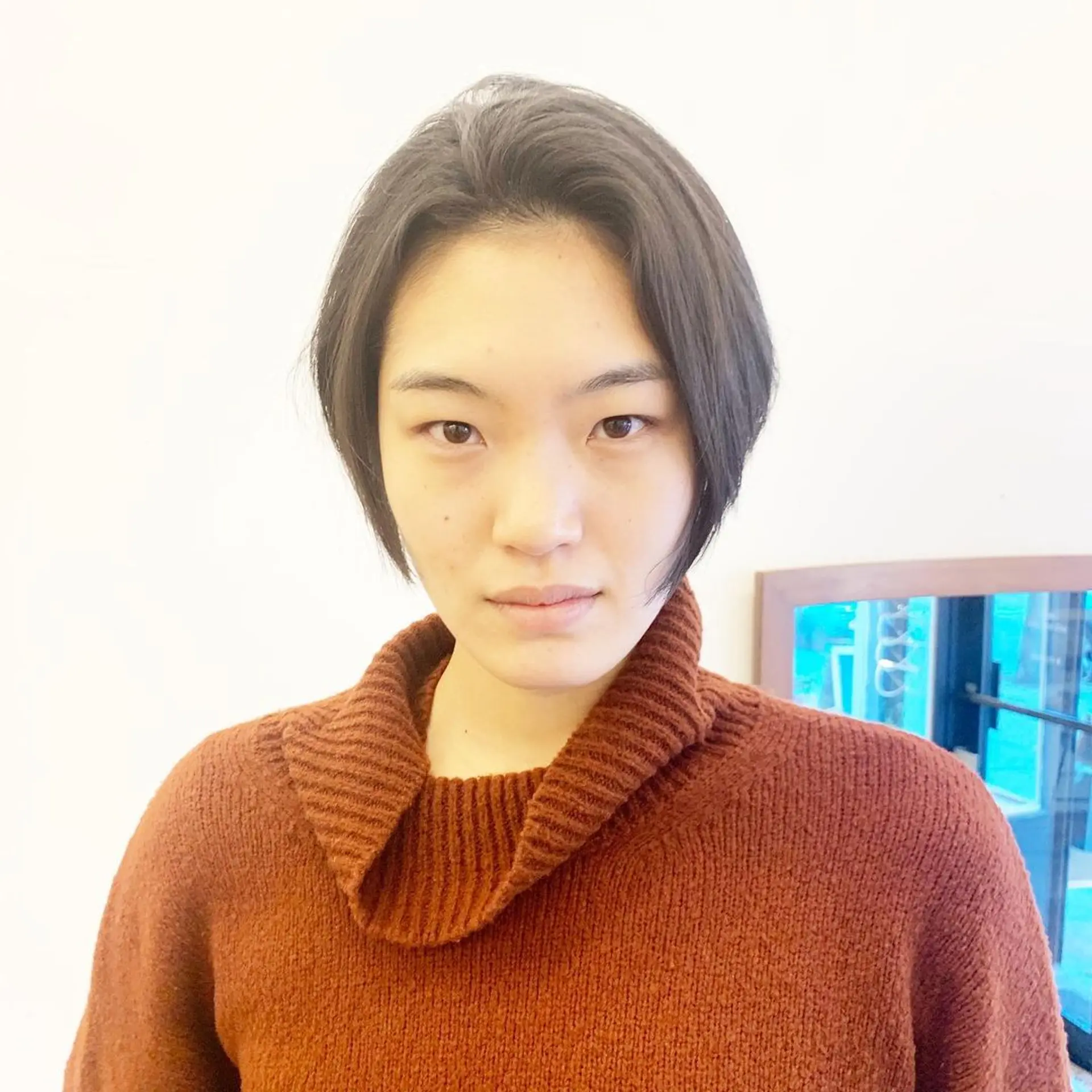 Sleek bob cut, ear-length, side-parted, minimal layers, straight black hair with natural shine by Takeo. 1