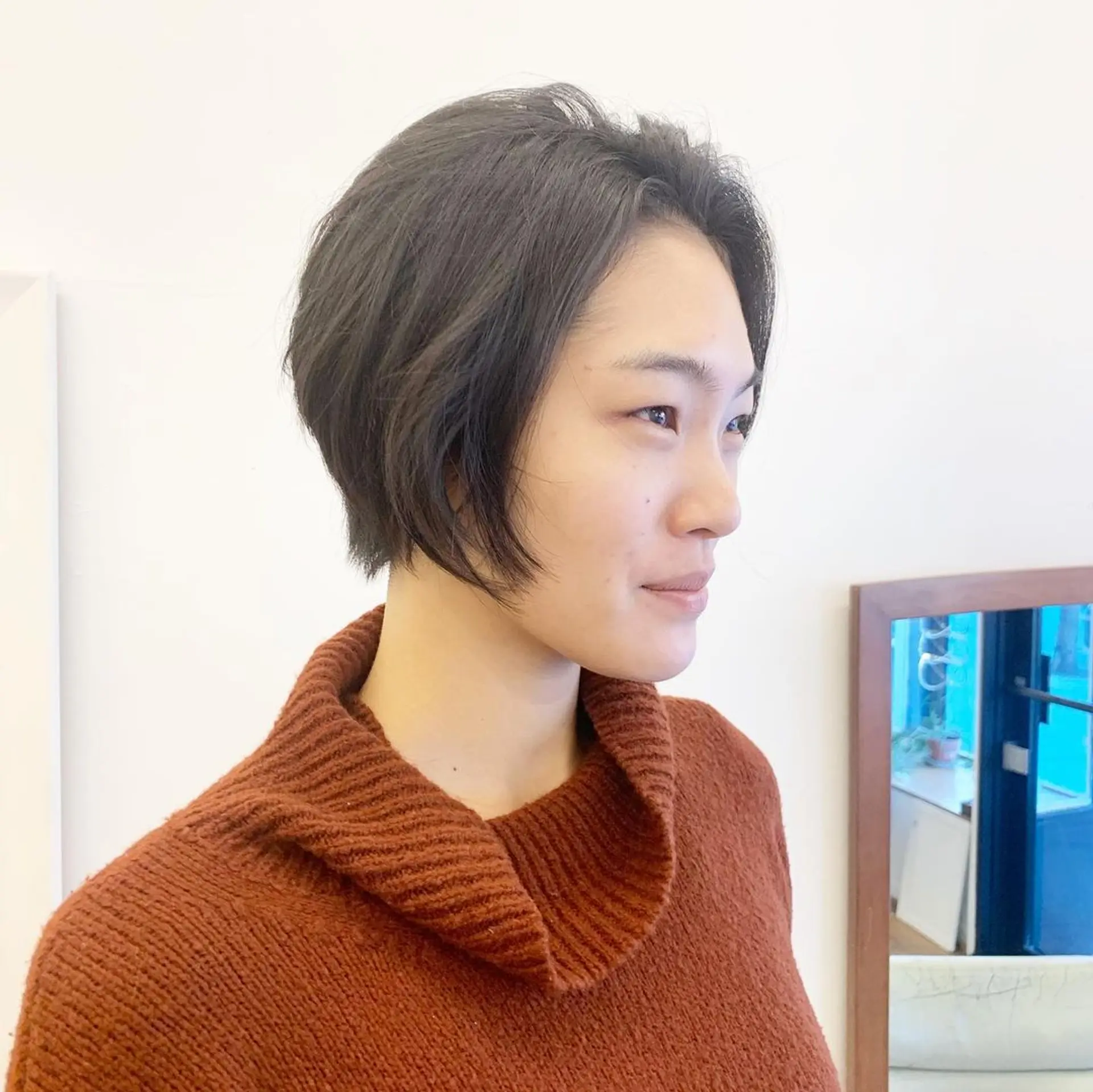 Sleek bob cut, ear-length, side-parted, minimal layers, straight black hair with natural shine by Takeo. 3