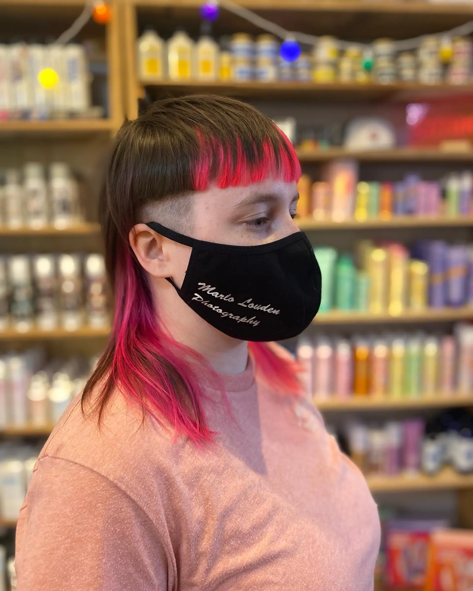 A modern take on the classic mullet with pink highlights and undercut. 1