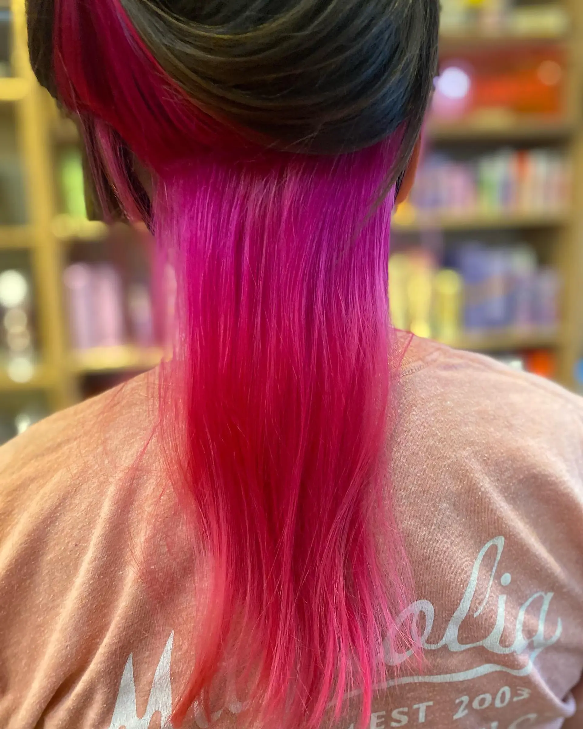 A modern take on the classic mullet with pink highlights and undercut. 2