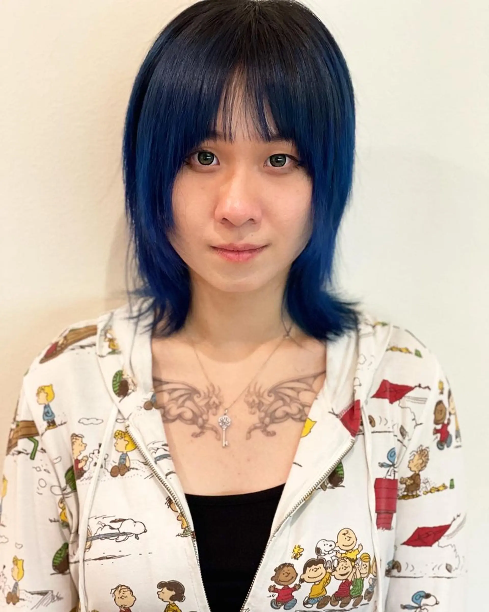 A trendy wolf cut with layered, shaggy texture and face-framing bangs. 1