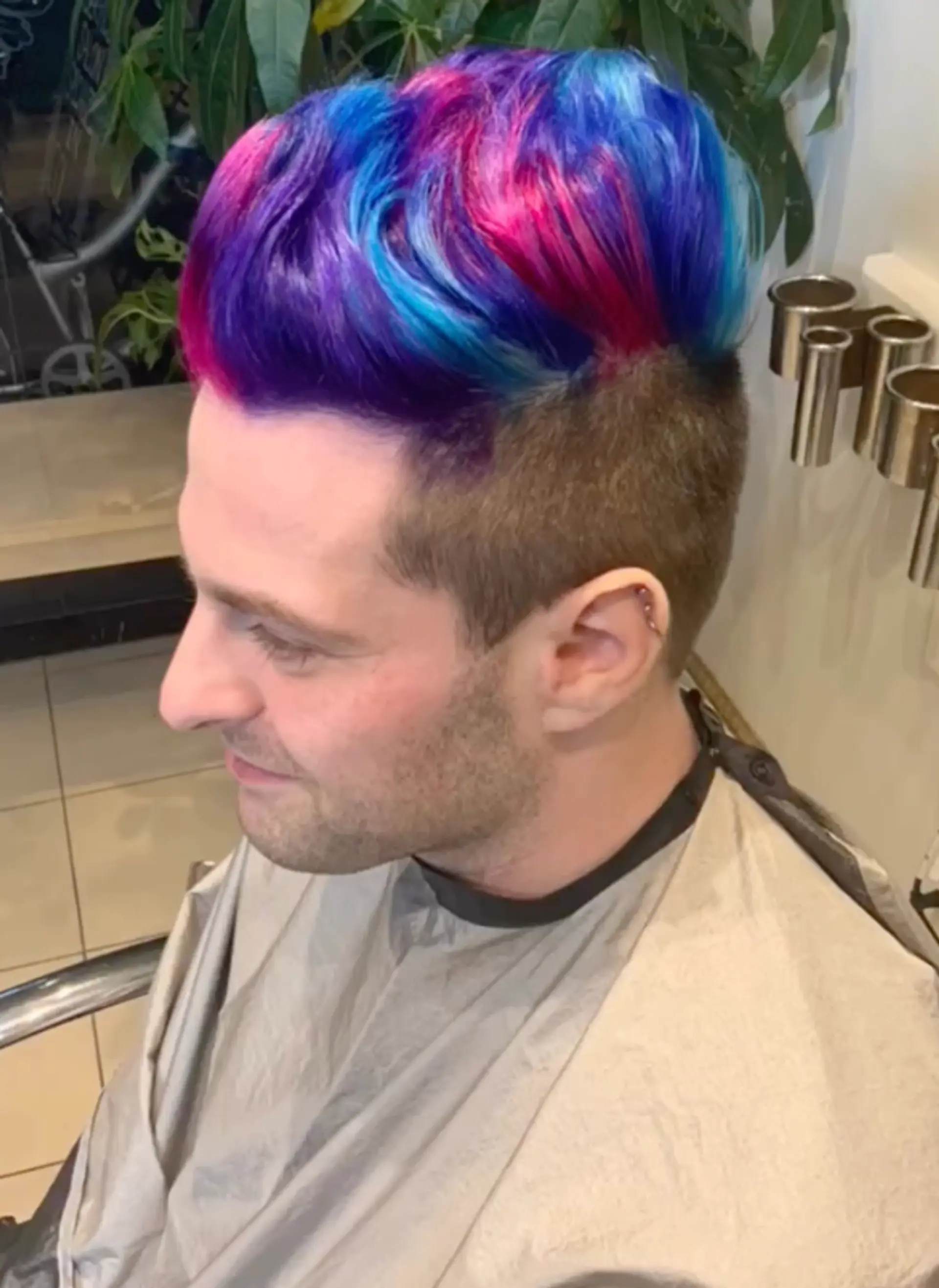 A short, edgy undercut with a vibrant mix of neon colors on top. 1