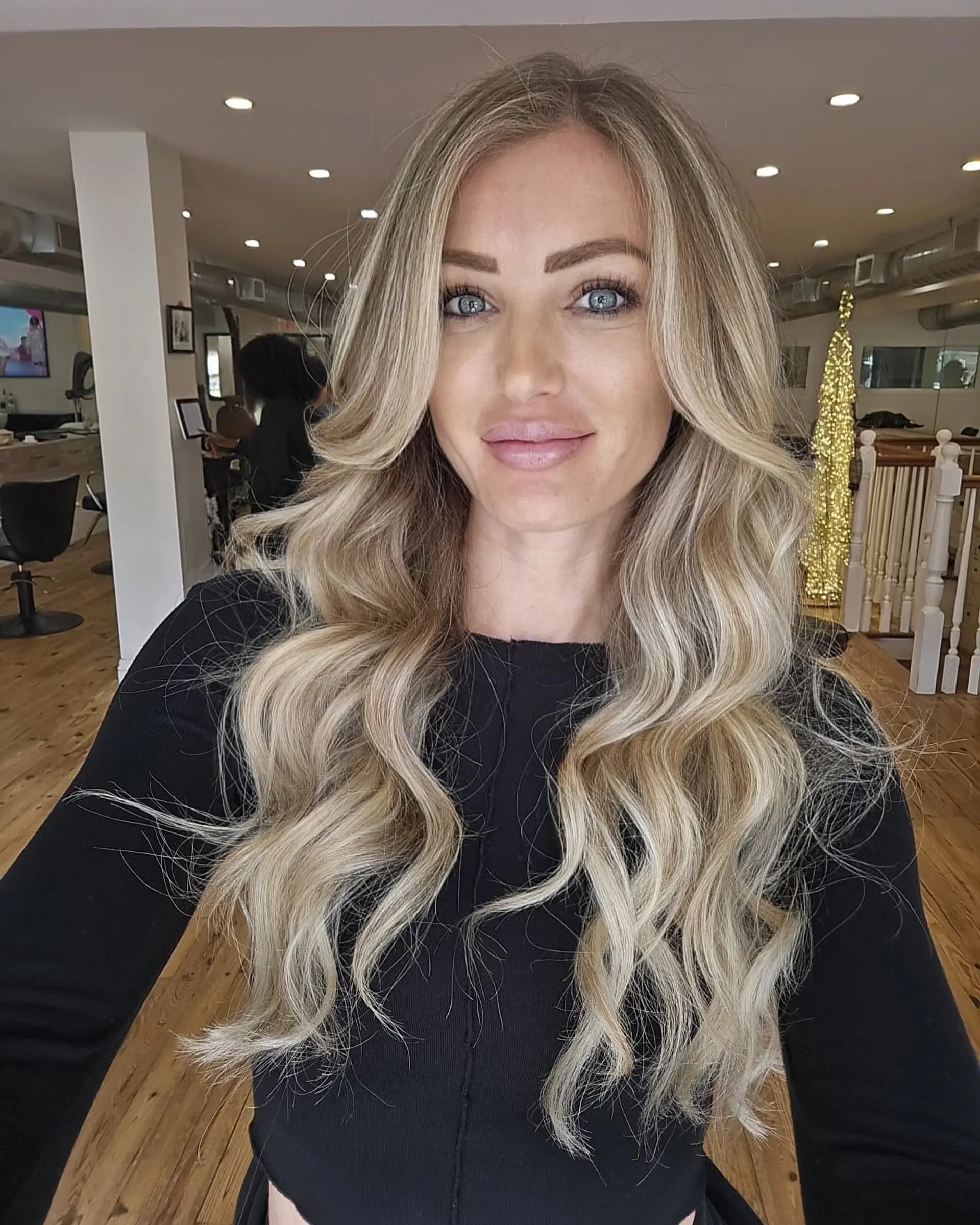 Long, beachy waves with a blend of blonde shades and subtle ash undertones. 1
