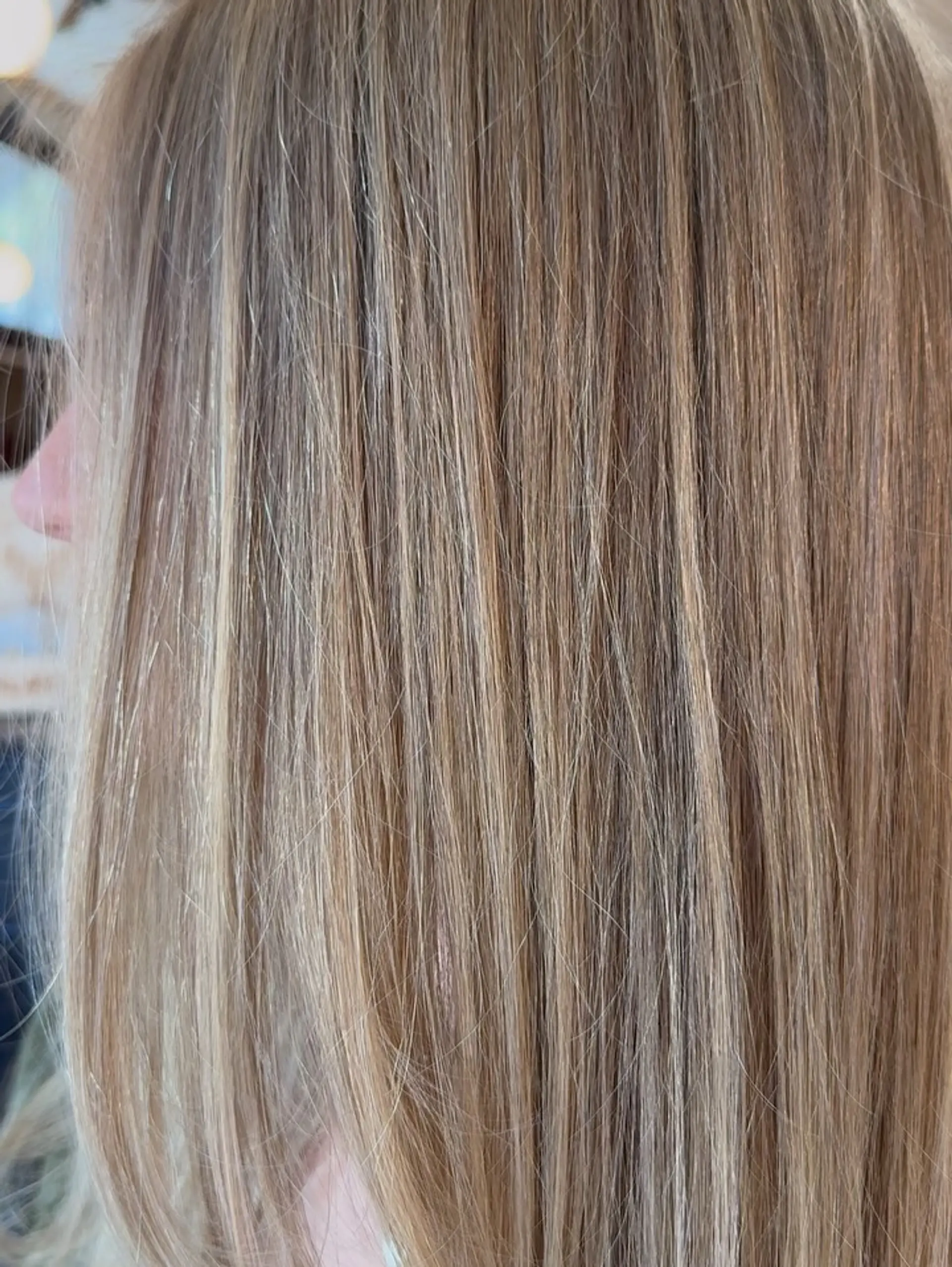 Straight hair featuring a blend of foils and hand-painted balayage in soft, creamy blonde tones. 1