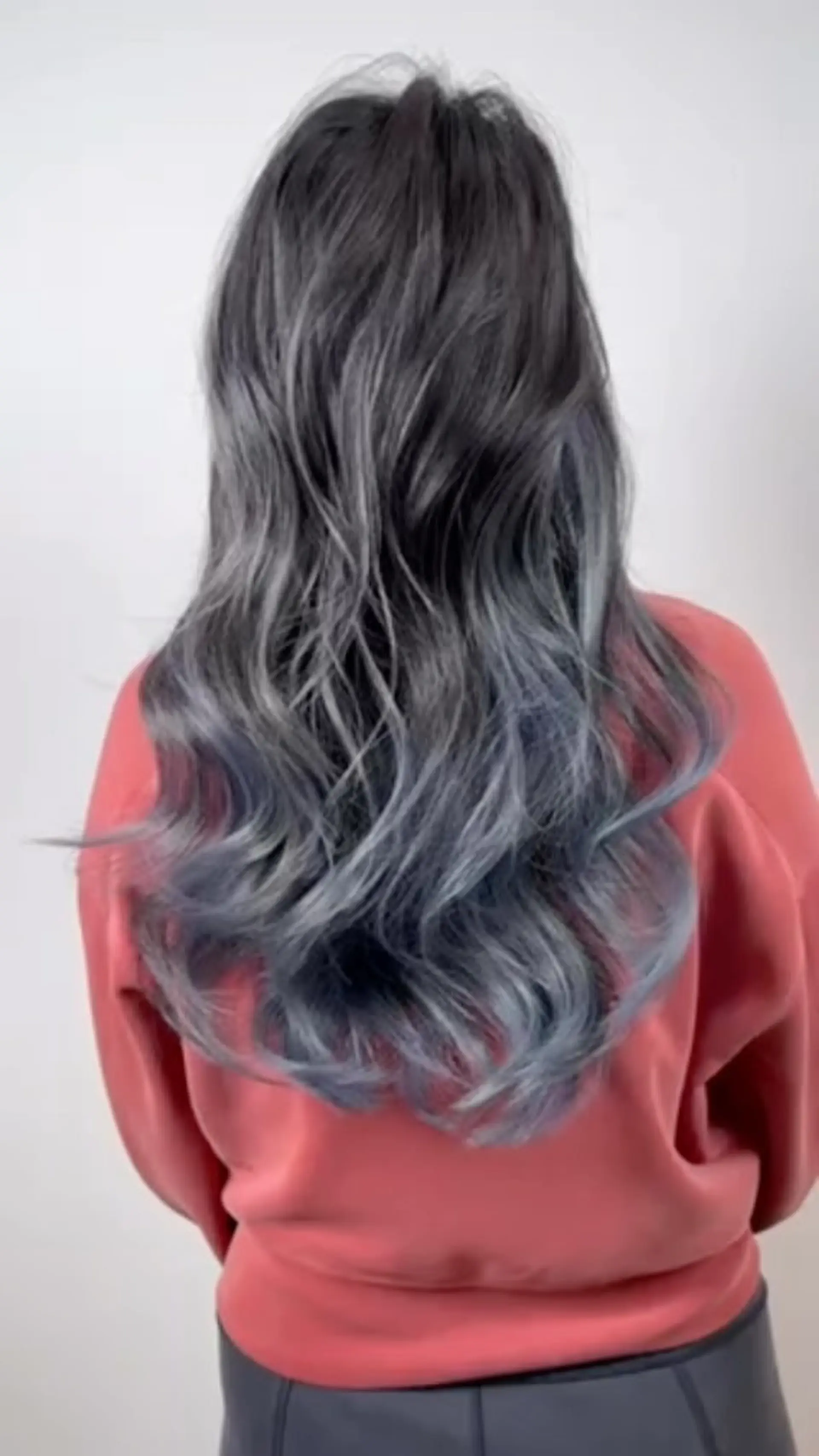 A long, wavy hairstyle featuring a dark brown base transitioning into a cool-toned blue ash balayage. 1