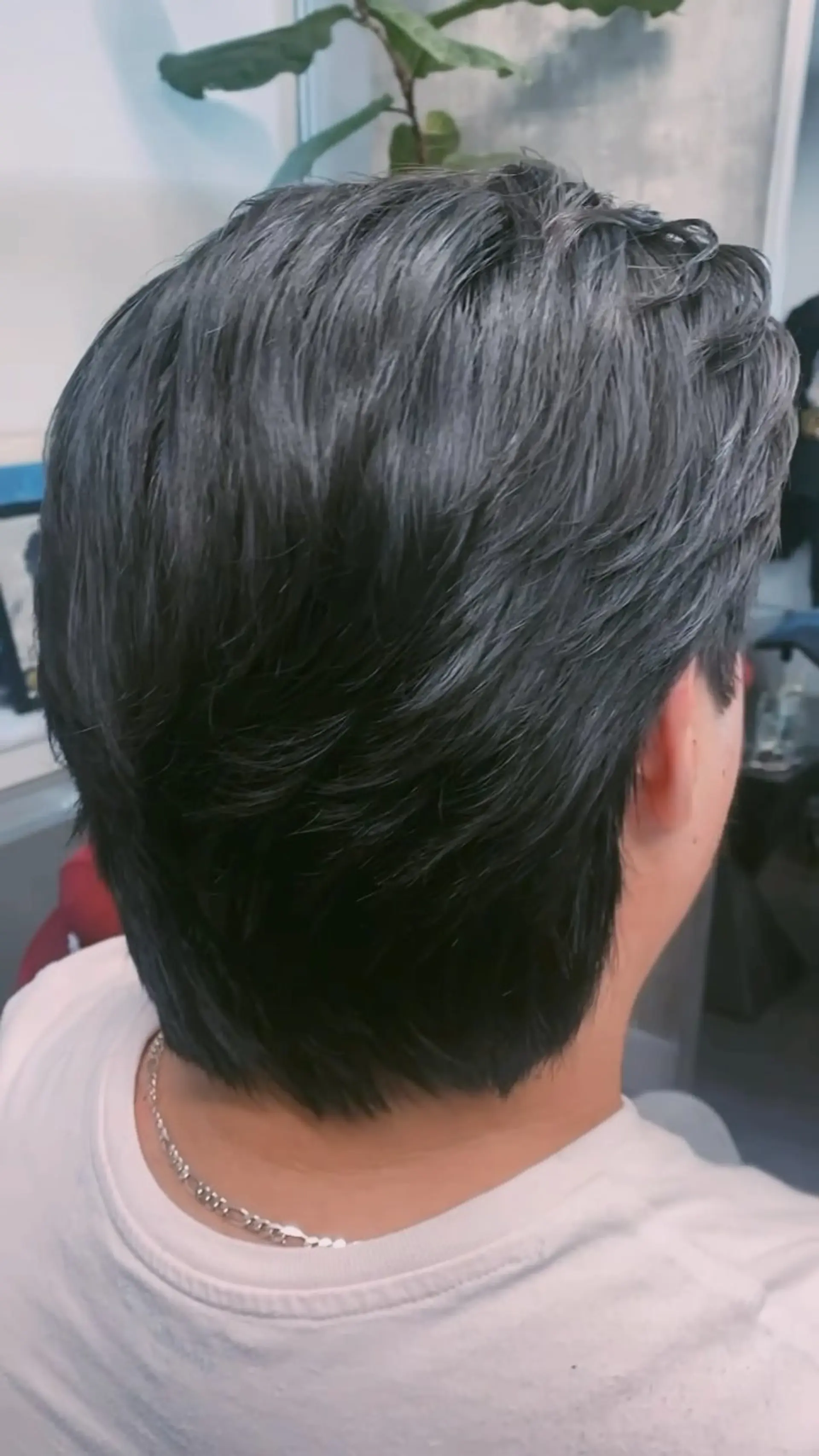 A textured medium-short scissor cut styled with soft layers flowing toward the back. 1