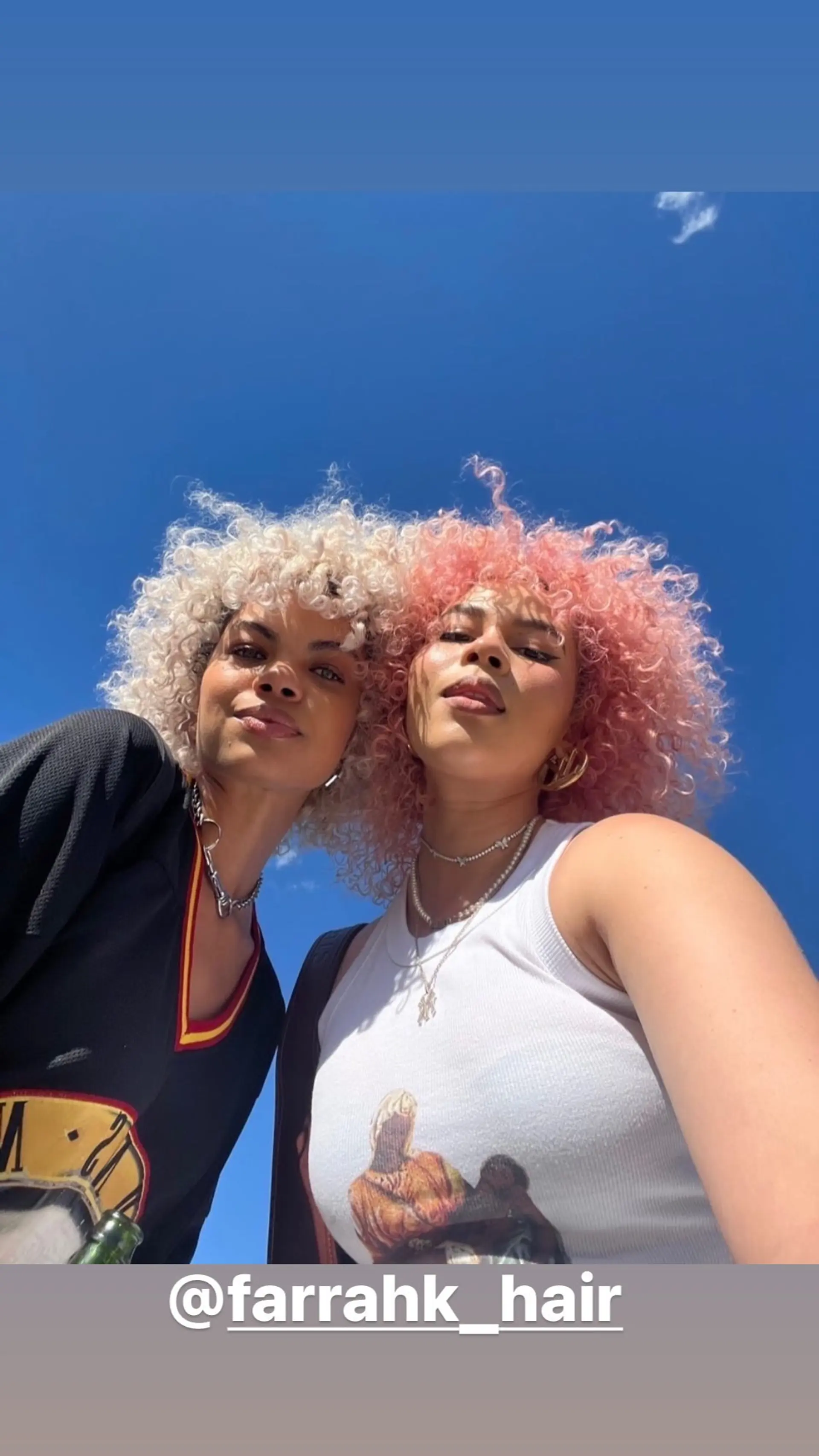 A trendy, medium-length curly hairstyle with a vibrant pastel color combination. 1