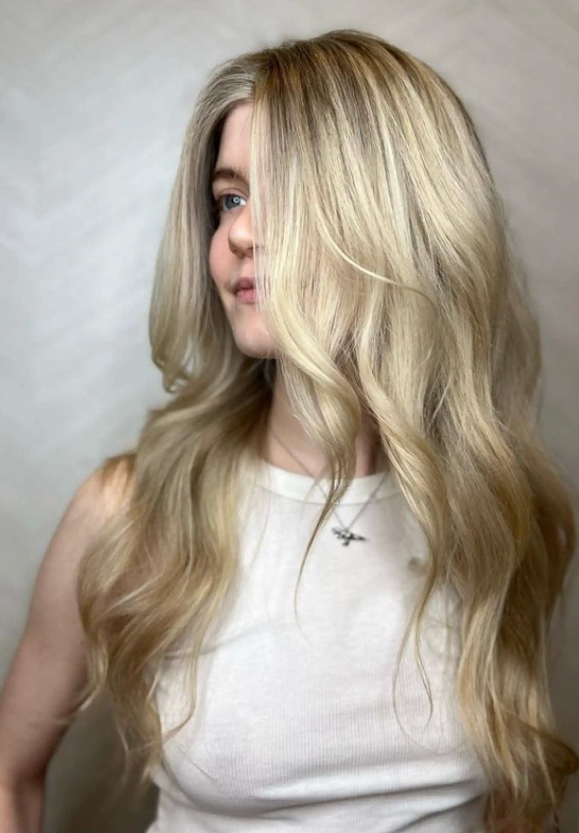 Very long, wavy blonde hair with golden highlights, soft waves, and loose curls forming a face-framing style.

 1