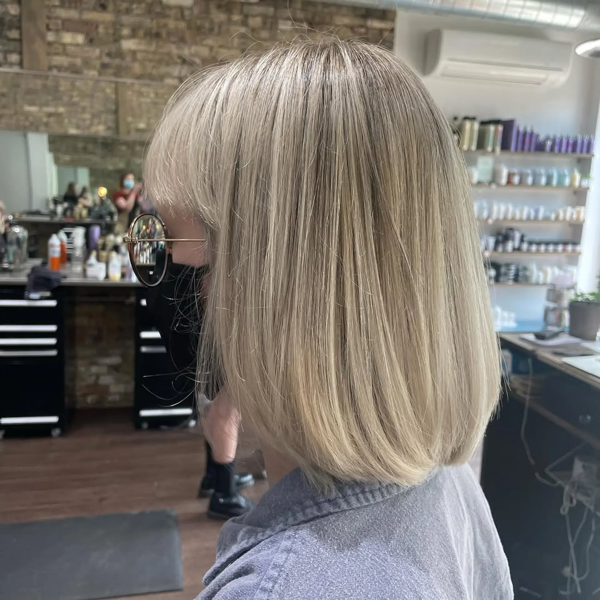 This chic, medium-length blunt bob showcases sleek, straight hair in a vibrant platinum blonde, creating a modern and polished aesthetic. 1