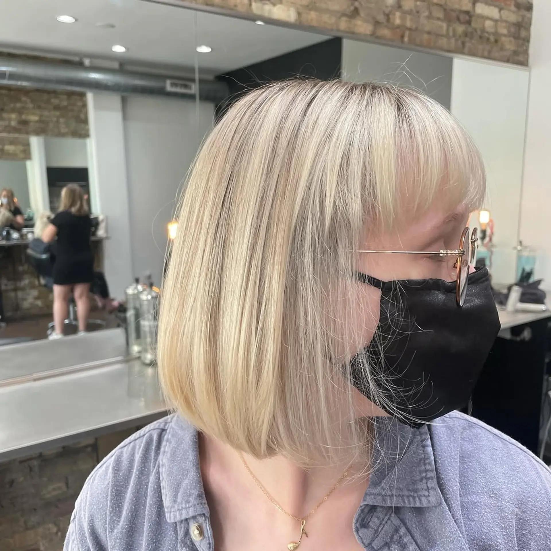 This chic, medium-length blunt bob showcases sleek, straight hair in a vibrant platinum blonde, creating a modern and polished aesthetic. 2