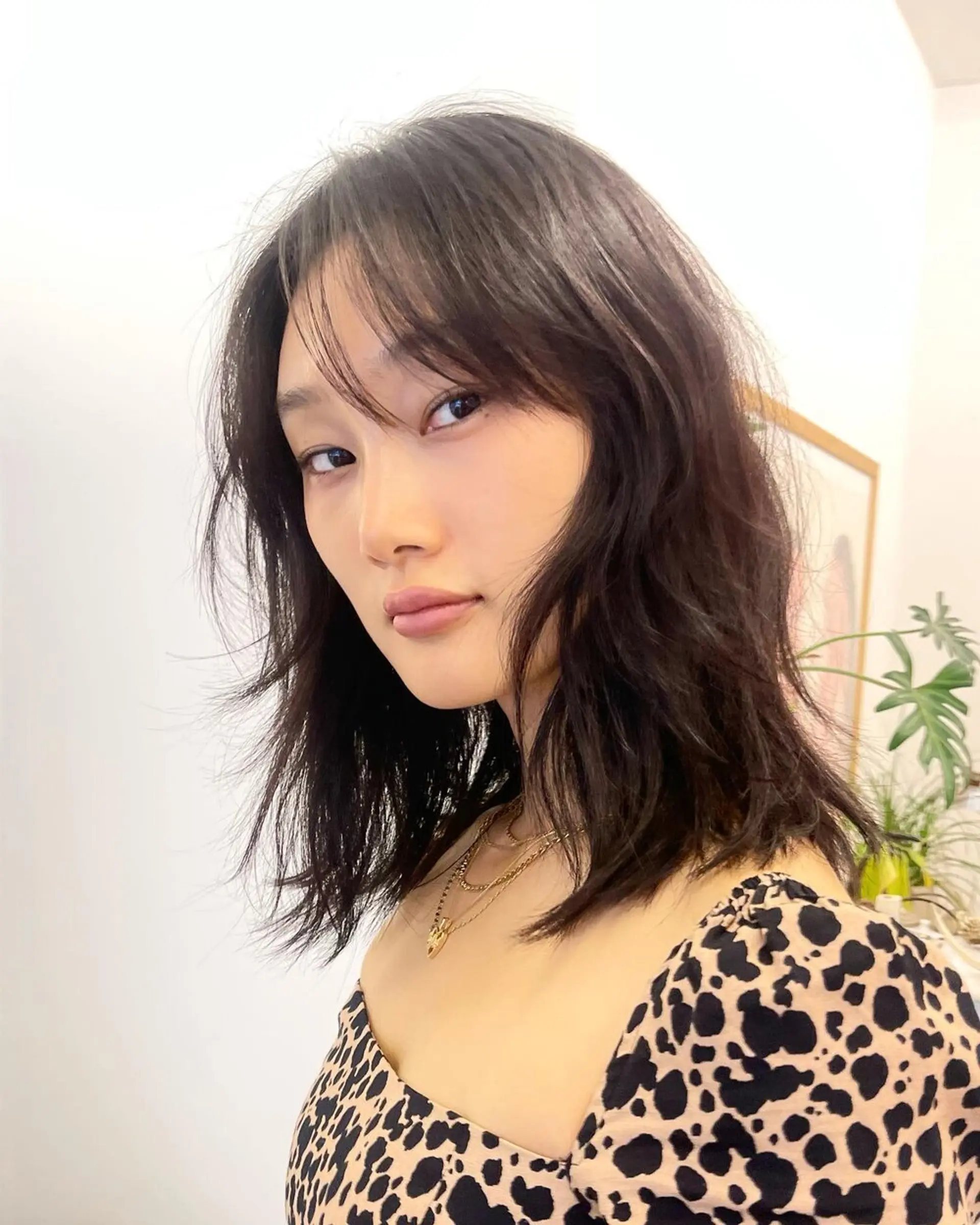 This medium-length hairstyle with dark brown hair features natural, wavy texture and face-framing layers. The waves are styled in a casual yet chic manner, giving a balanced look of elegance and ease. Haircut by @takeohair 1