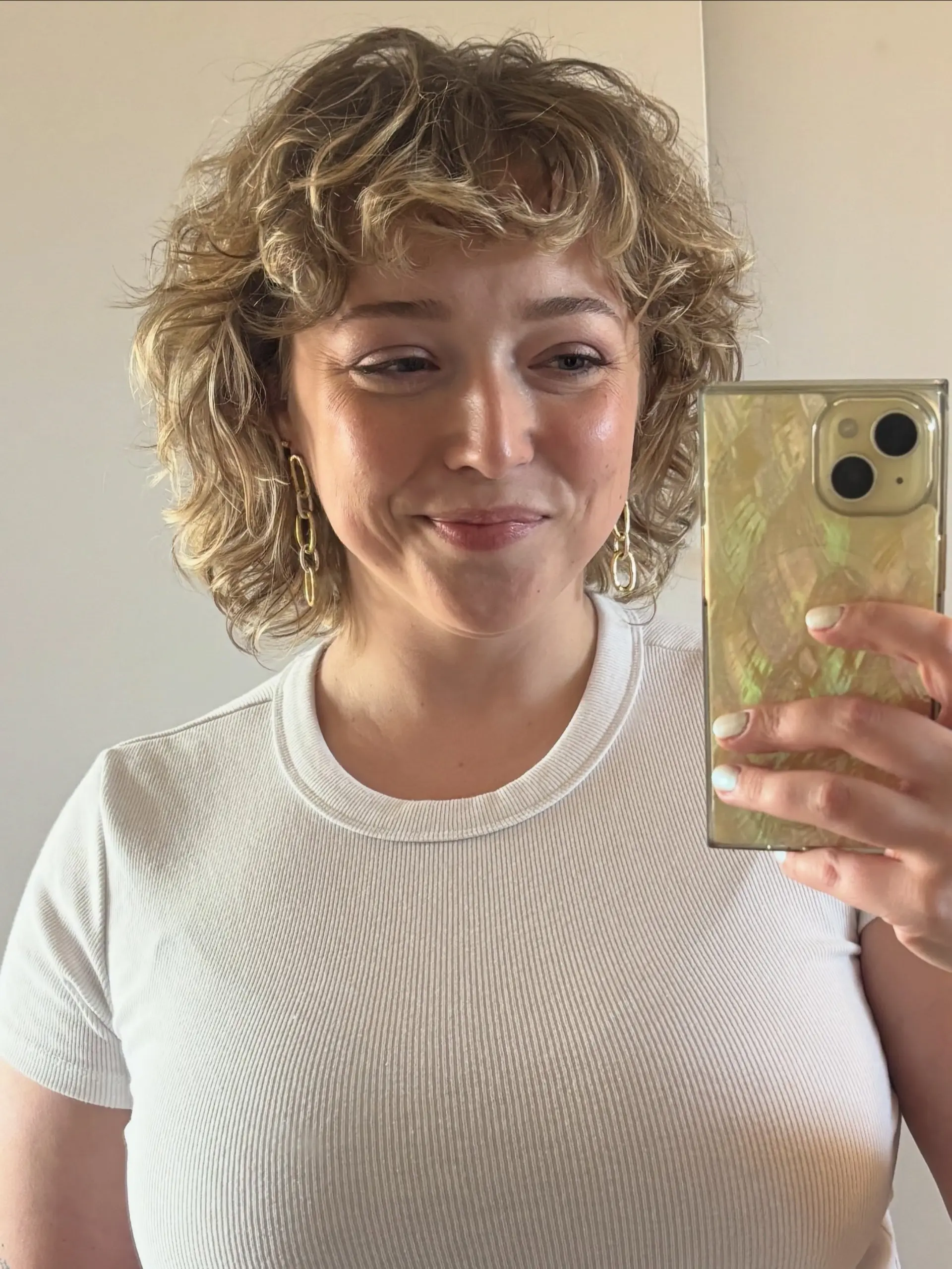 A textured, rounded shaggy bob cut with natural curls and wispy bangs framing the face. 1