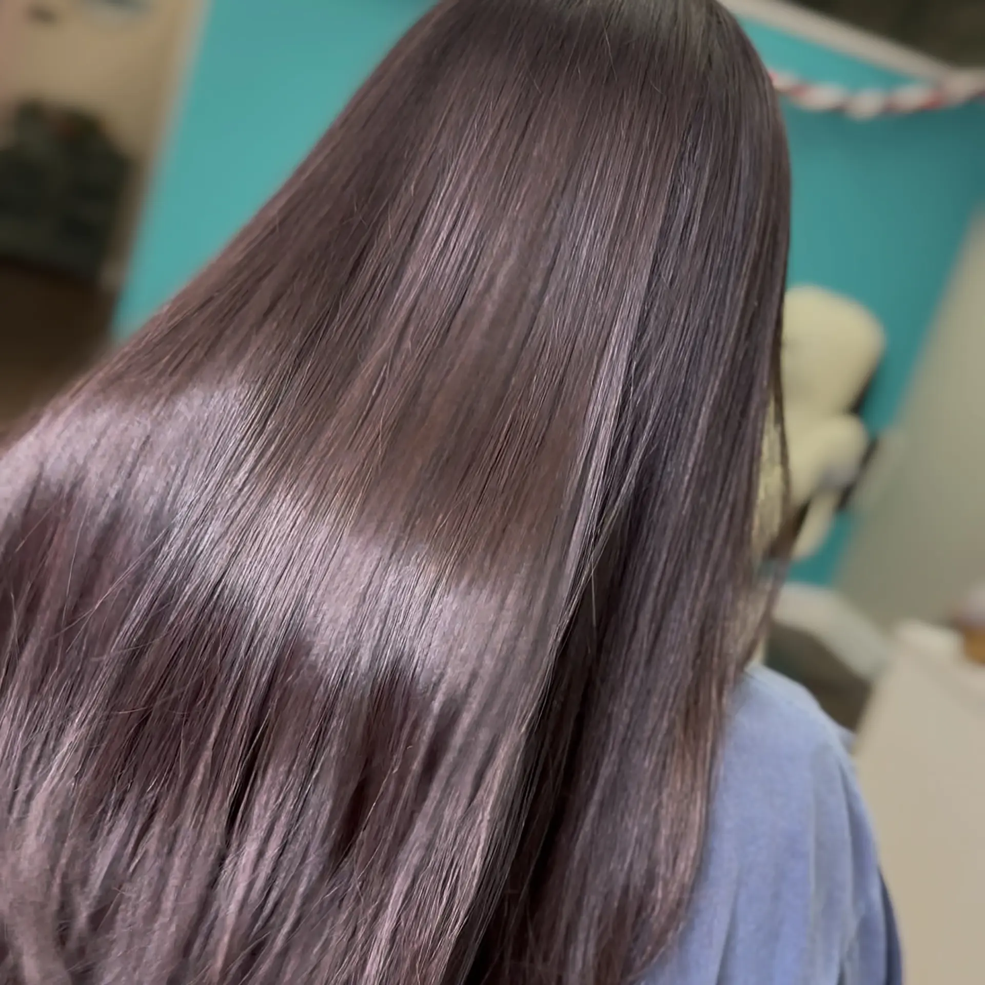 Long, ultra-smooth dark brown hair styled stick-straight with an intense reflective gloss. 1