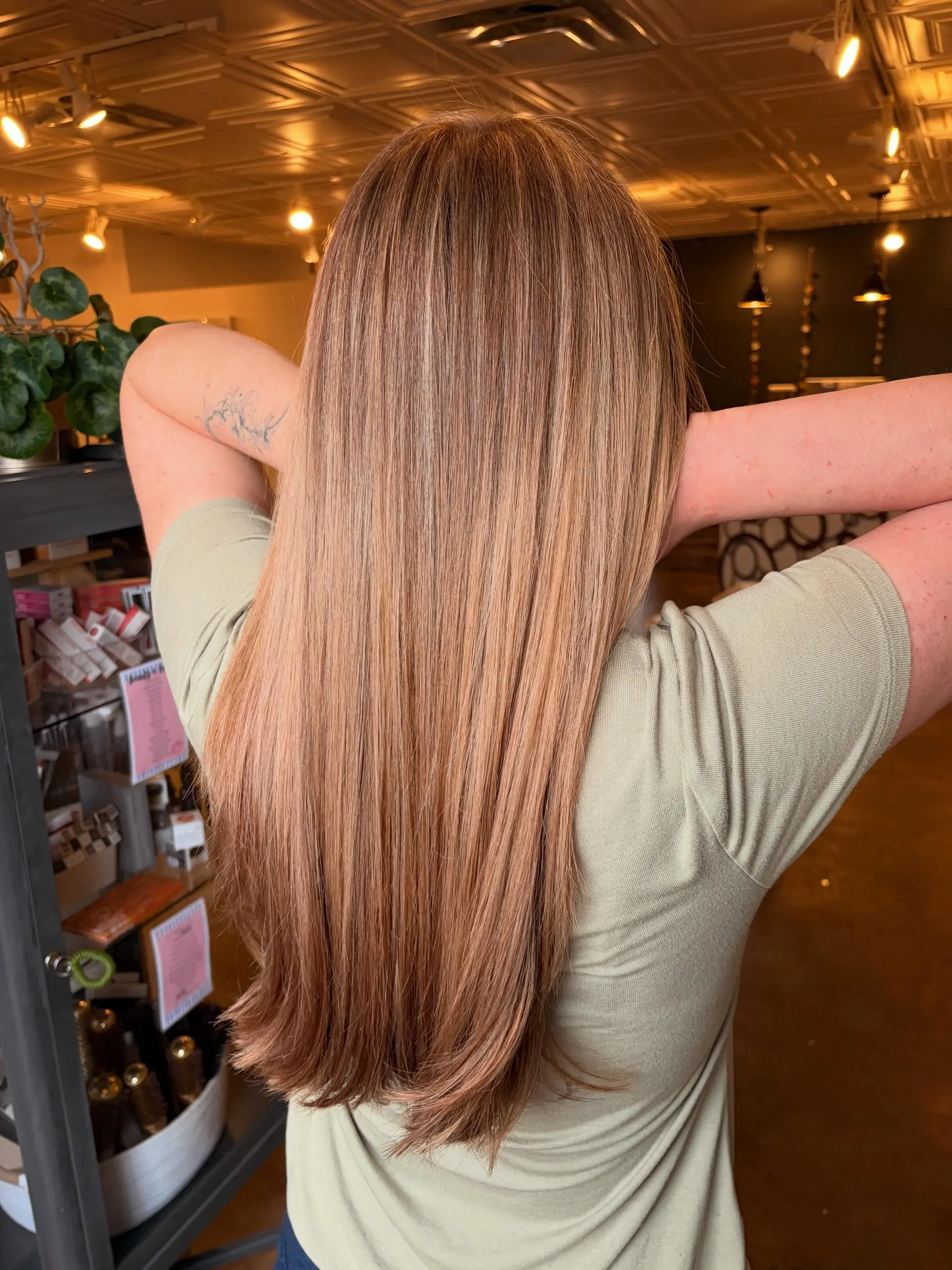 Long, pin-straight hair styled smoothly to highlight seamless buttery blonde dimensional highlights. 1