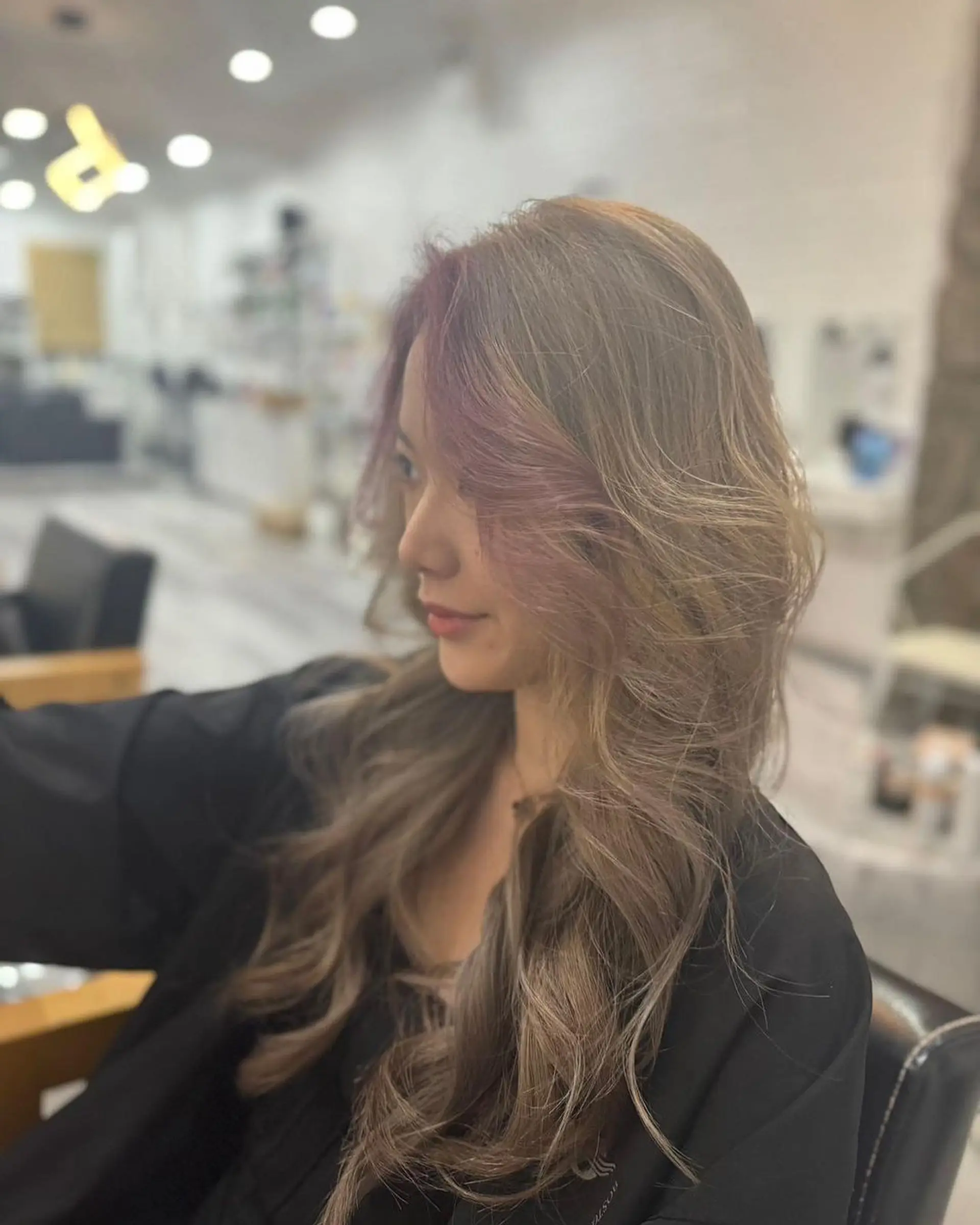 Long, wavy hair with light brown base color, blonde ombre, and pink highlights, styled in layers for added volume. 2