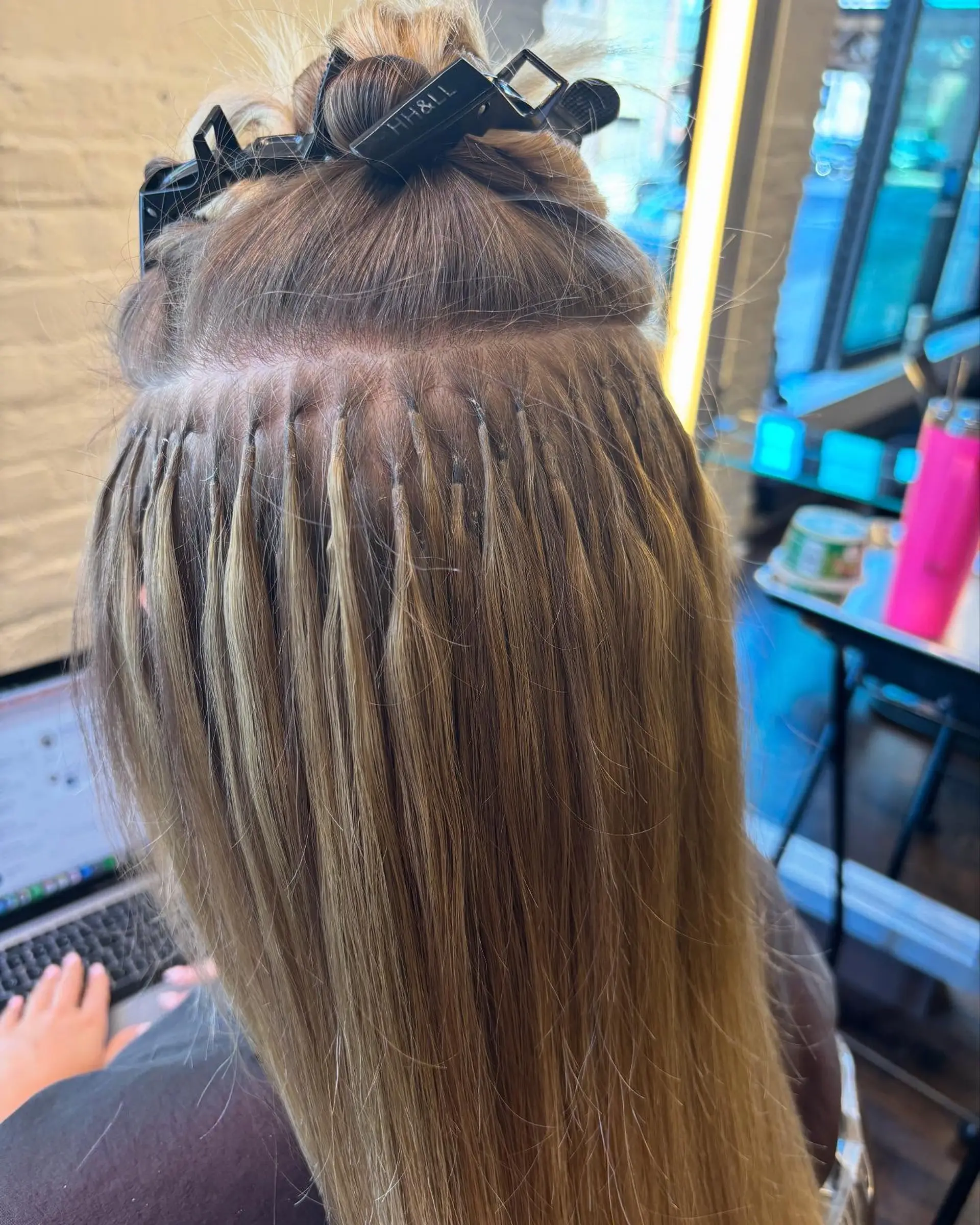 A long, straight hairstyle with a seamless blend of light blonde tones using the balayage technique, creating a buttery blonde effect with face framing layers and a subtle shadow root. 2